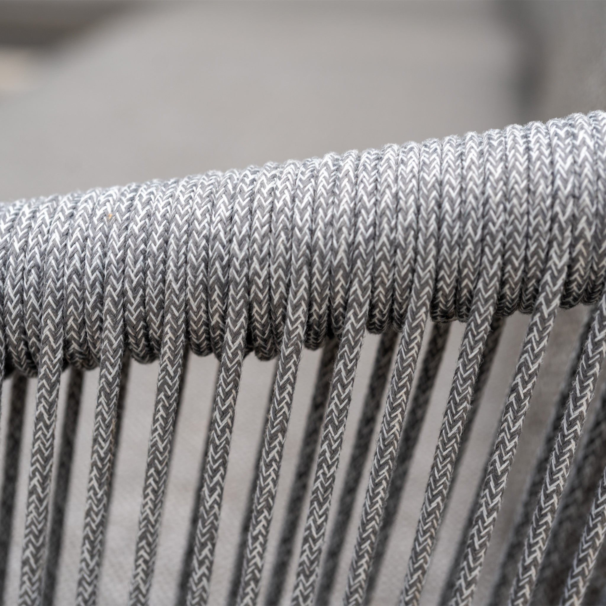 Close-up of tightly woven gray and white cord forming vertical lines on the Dekota Large Corner Sofa Dining Set with Altura Rising Table in Charcoal, highlighting its modern design ideal for outdoor dining.