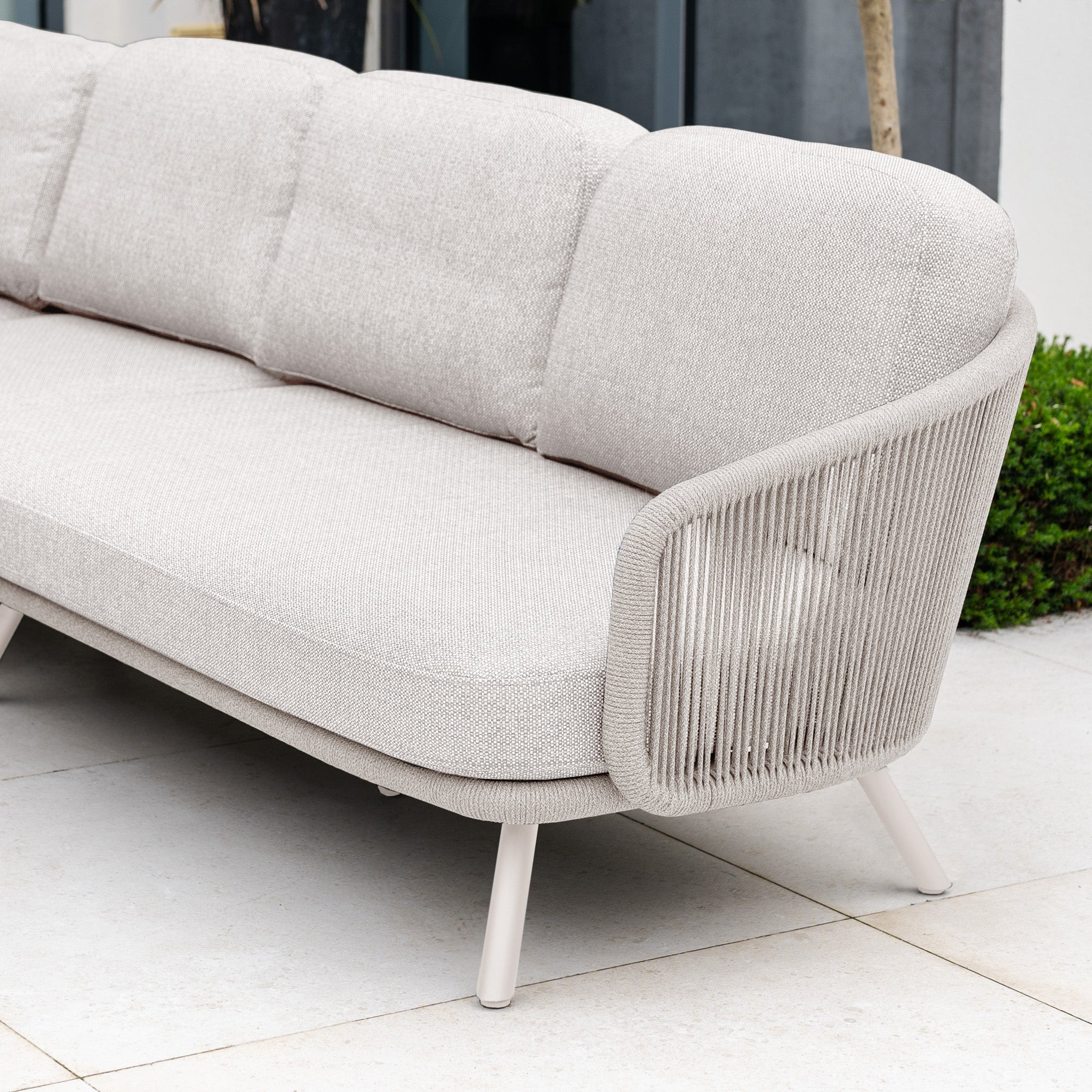 The Dekota Large Corner Sofa Set in Fawn features textured cushions and hydrophobic rope weave armrests, making it a stylish choice for outdoor patios.