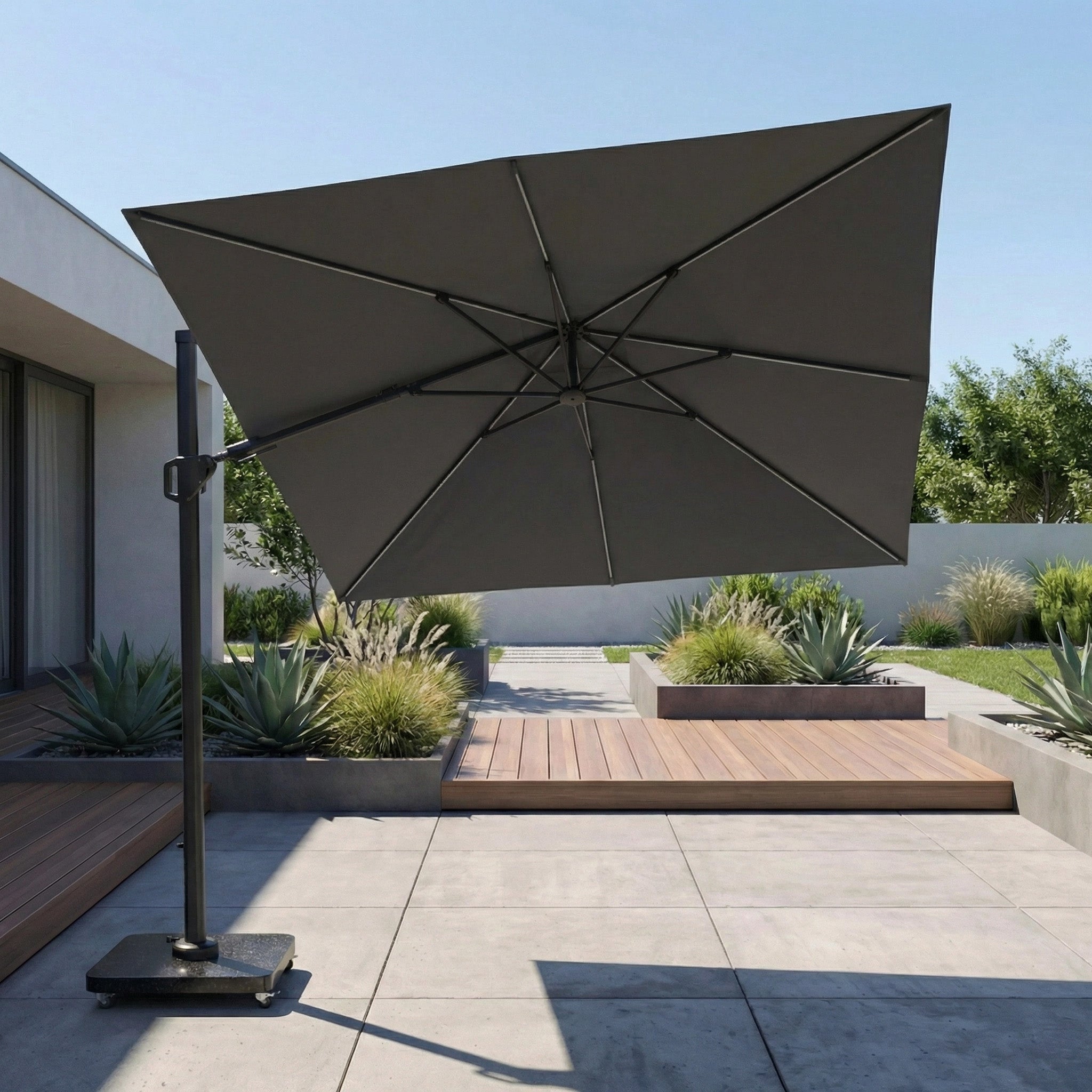 The Pacific Lifestyle Glow Challenger T2 3m Square Cantilever Parasol in Grey offers waterproof shade for modern outdoor areas with plants and wooden decking.