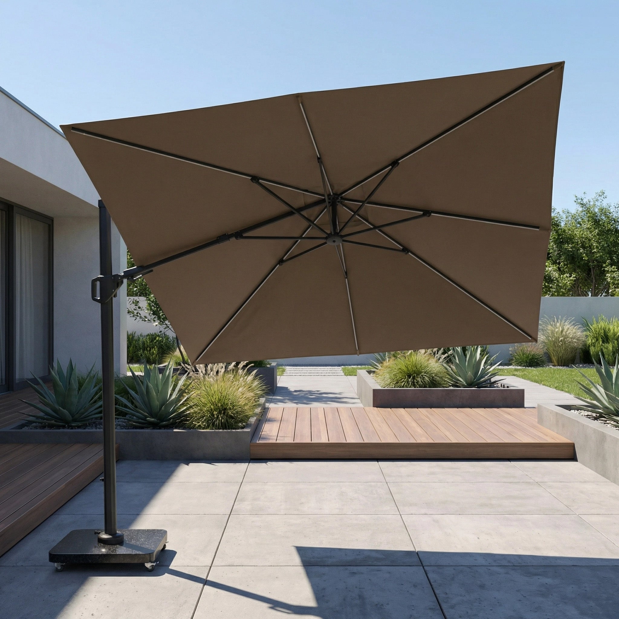 The Glow Challenger T2 3m Square Cantilever Parasol in Taupe offers stylish shade for modern patios with plants and wooden decking.