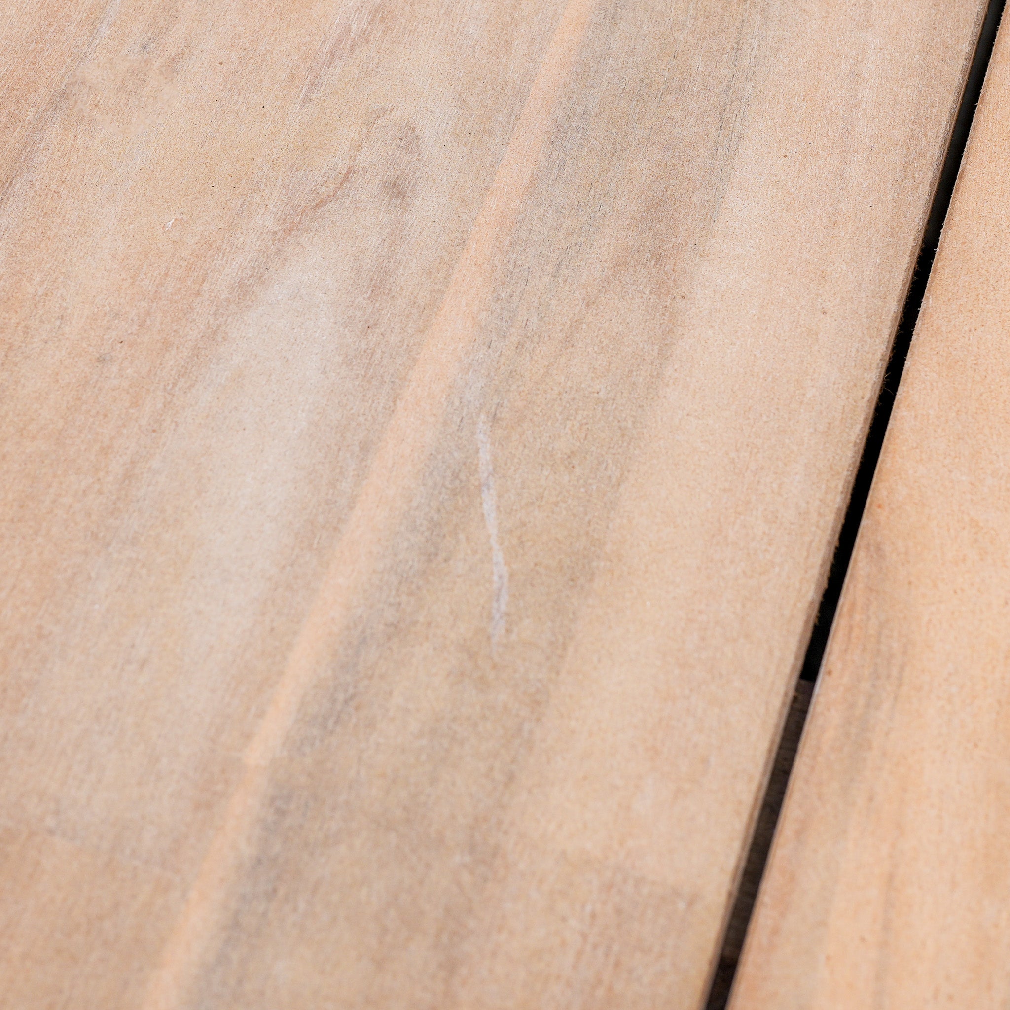 Close-up of Paia 8 Seat Round Dining Set (Ex Display) showing light-colored Acacia wood planks with visible grain and a narrow gap between two boards.