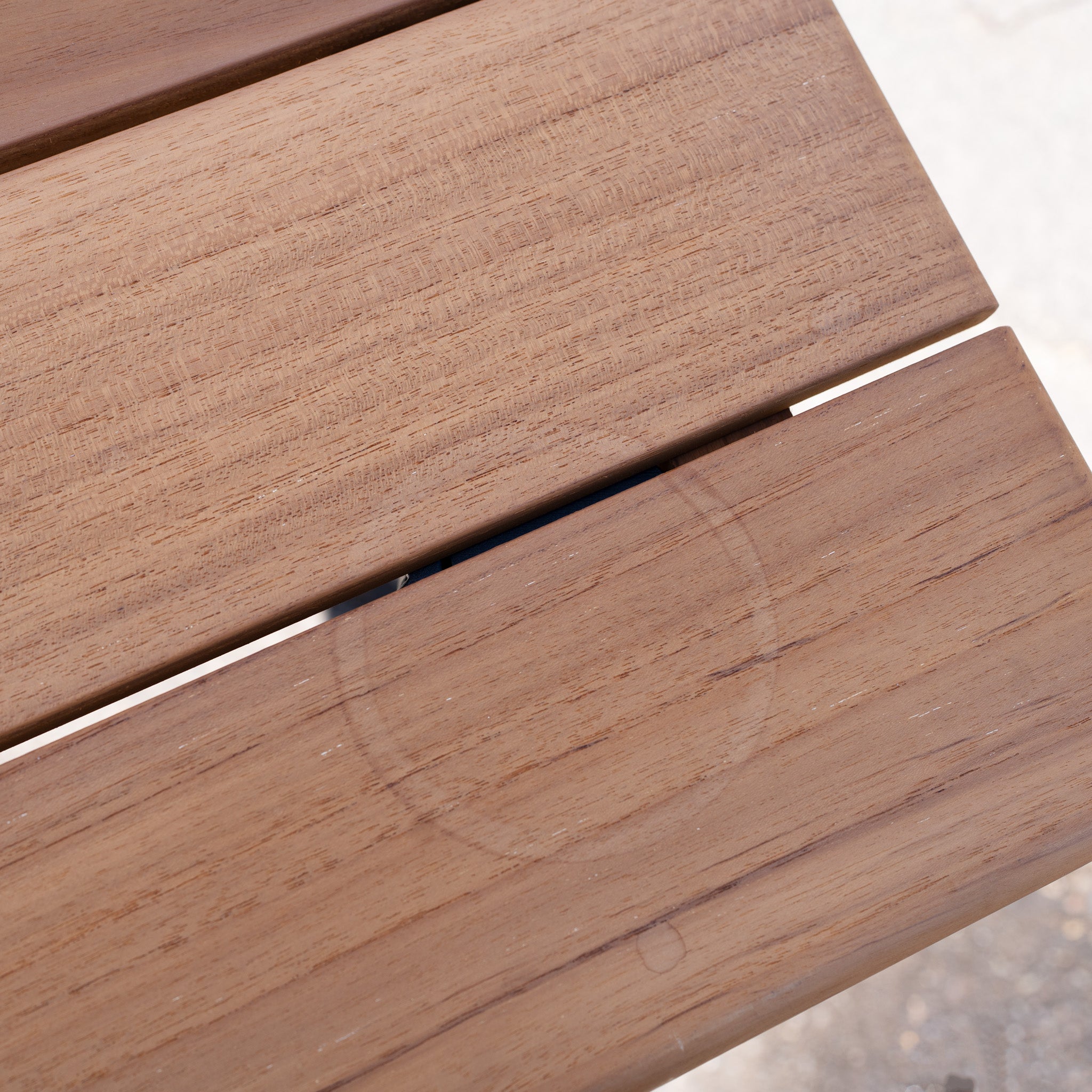 The Bay 8 Seat Dining Table in Charcoal (Ex Display) features a faint circular ring mark on one of its planks.