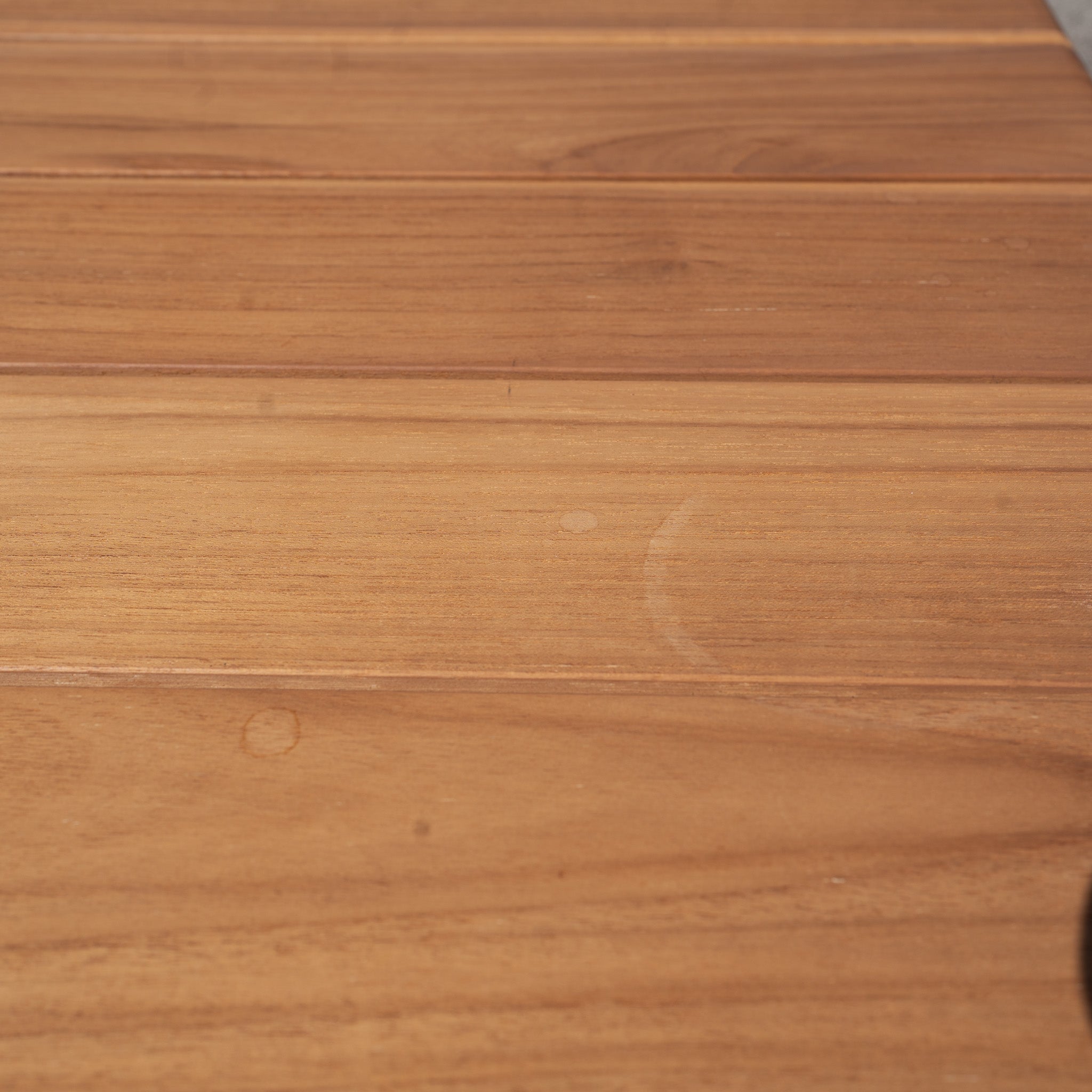 Close-up of the Bay 8 Seat Dining Table in Charcoal (Ex Display) reveals its wood grain and rich finish—ideal for upgrading your outdoor dining space. See our care guide to keep your table looking beautiful.