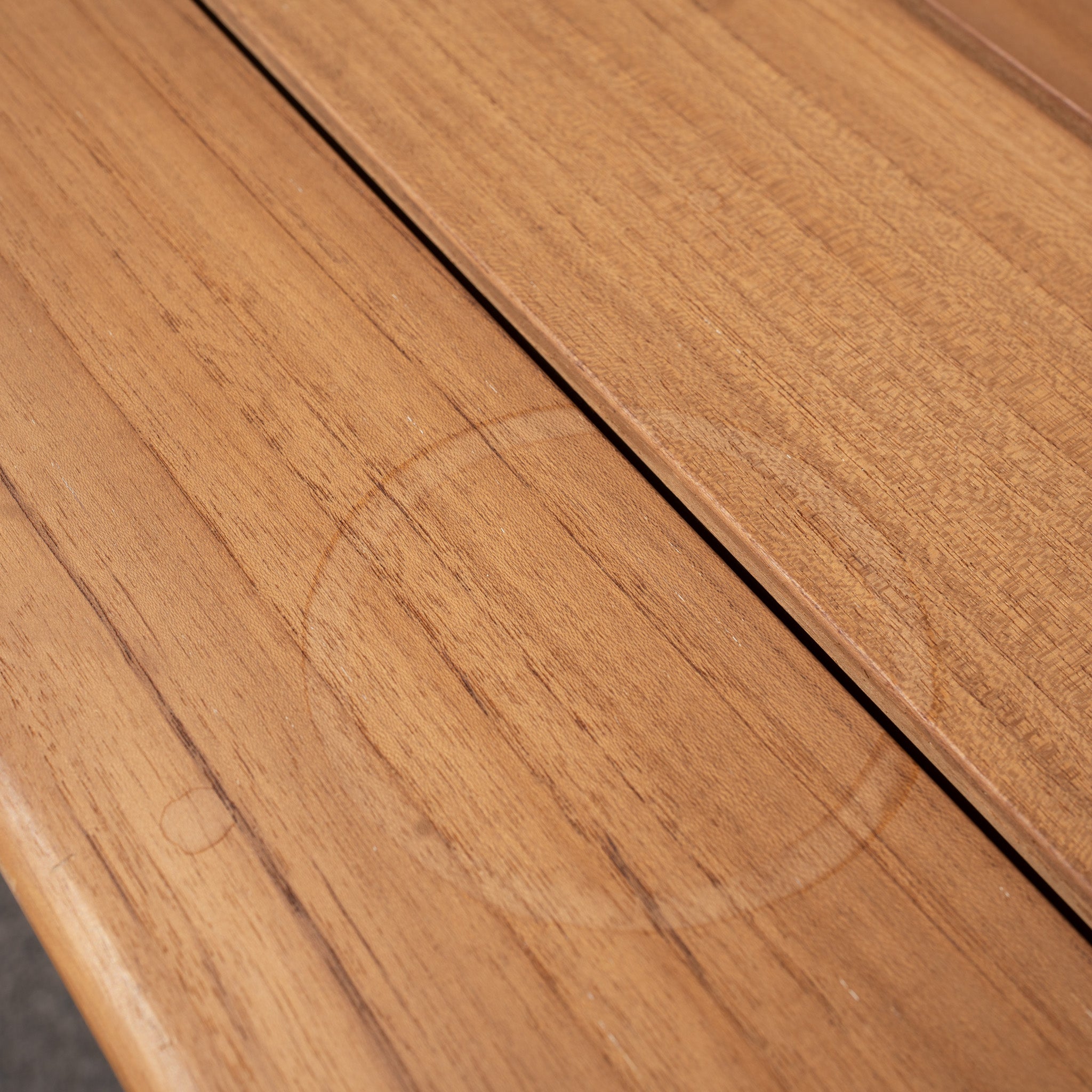 The Bay 8 Seat Dining Table in Charcoal (Ex Display) has a visible circular water stain on the surface—refer to our wooden care guide for maintenance tips.