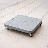 The Siesta 125kg Granite Base, a square gray parasol base with handles and wheels, is ideal for supporting outdoor parasols and modern cantilever designs on light tiled floors.