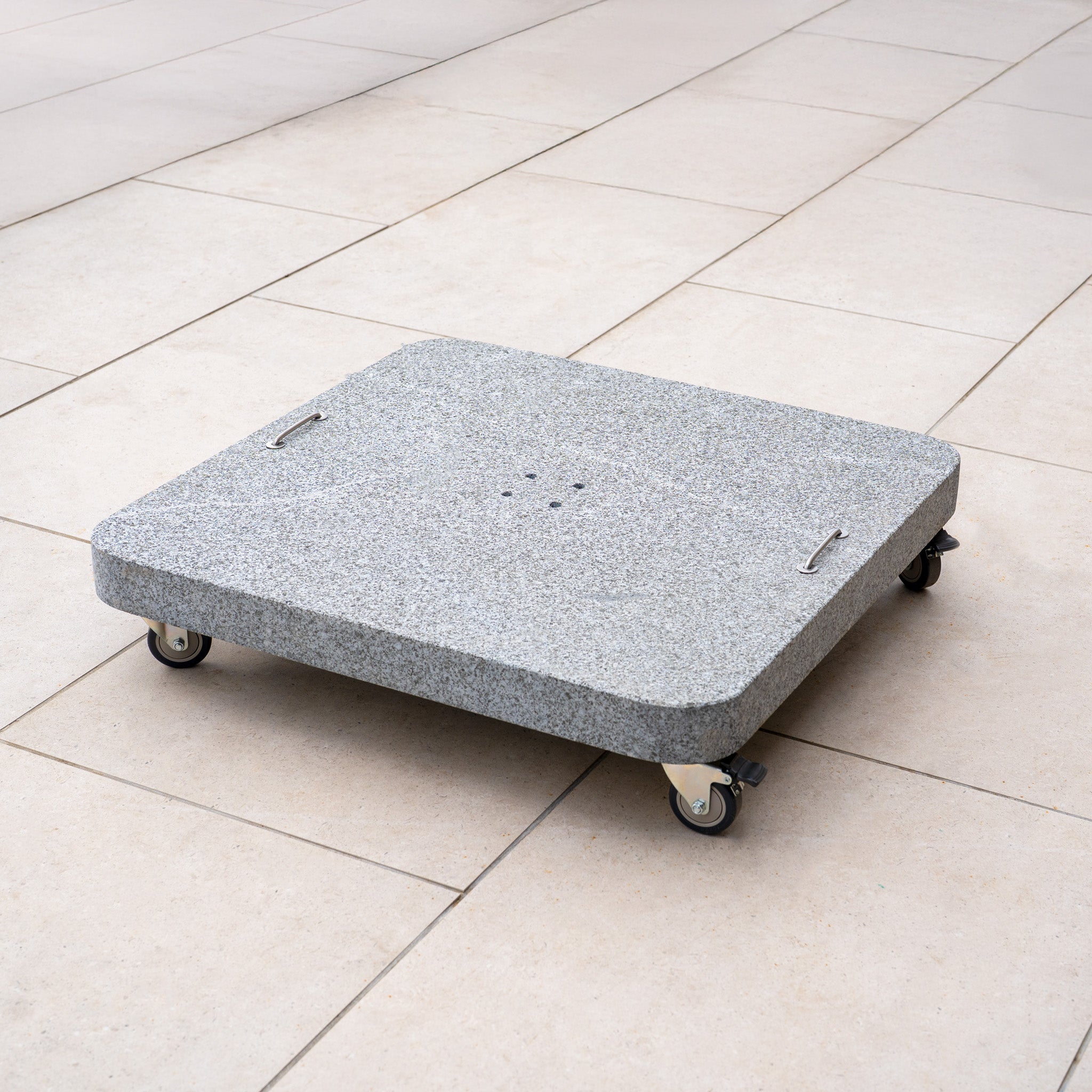 The Siesta 125kg Granite Base, a square gray parasol base with handles and wheels, is ideal for supporting outdoor parasols and modern cantilever designs on light tiled floors.