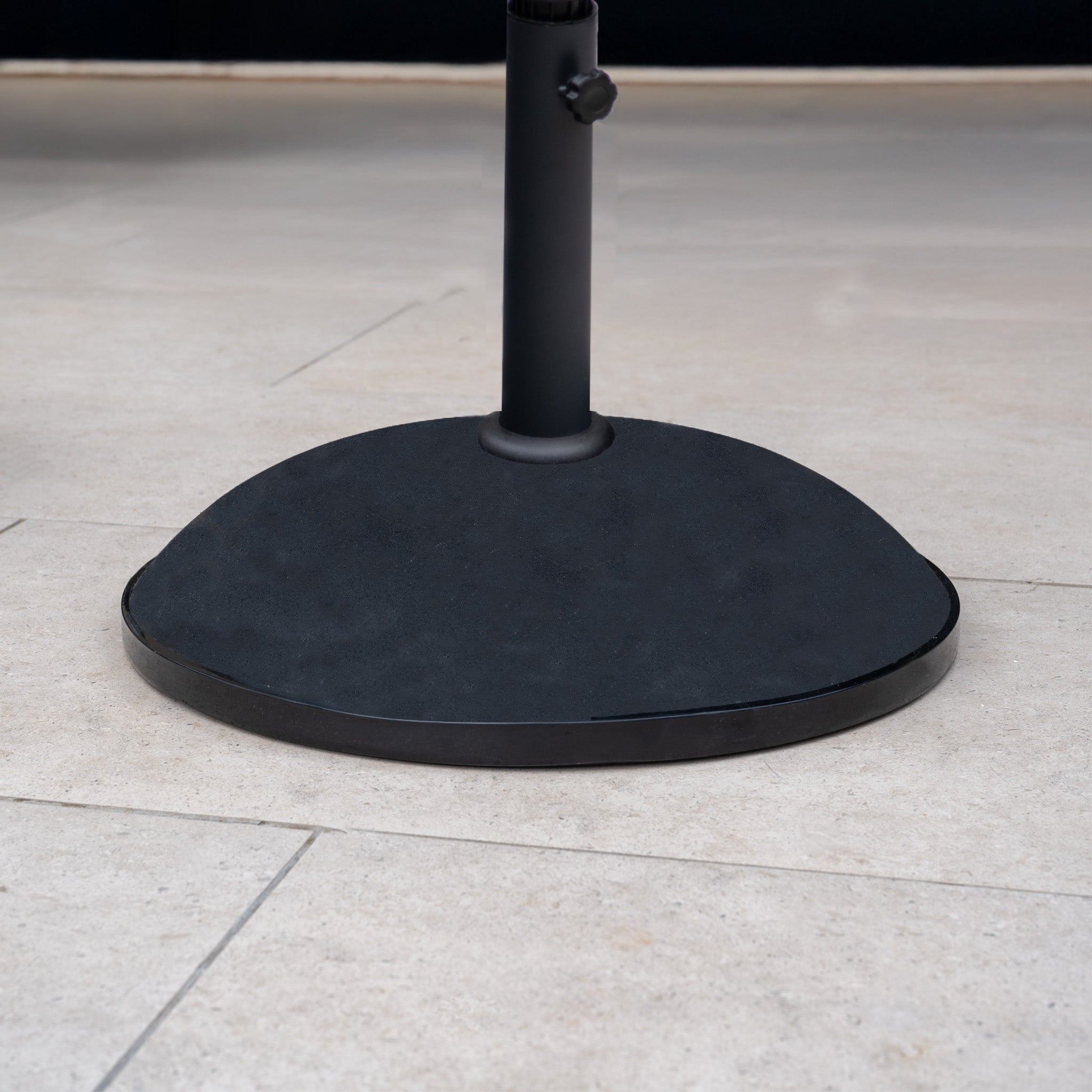 The 50kg Concrete Parasol Base sits on a light-colored tiled floor, providing sturdy support for your outdoor umbrella.