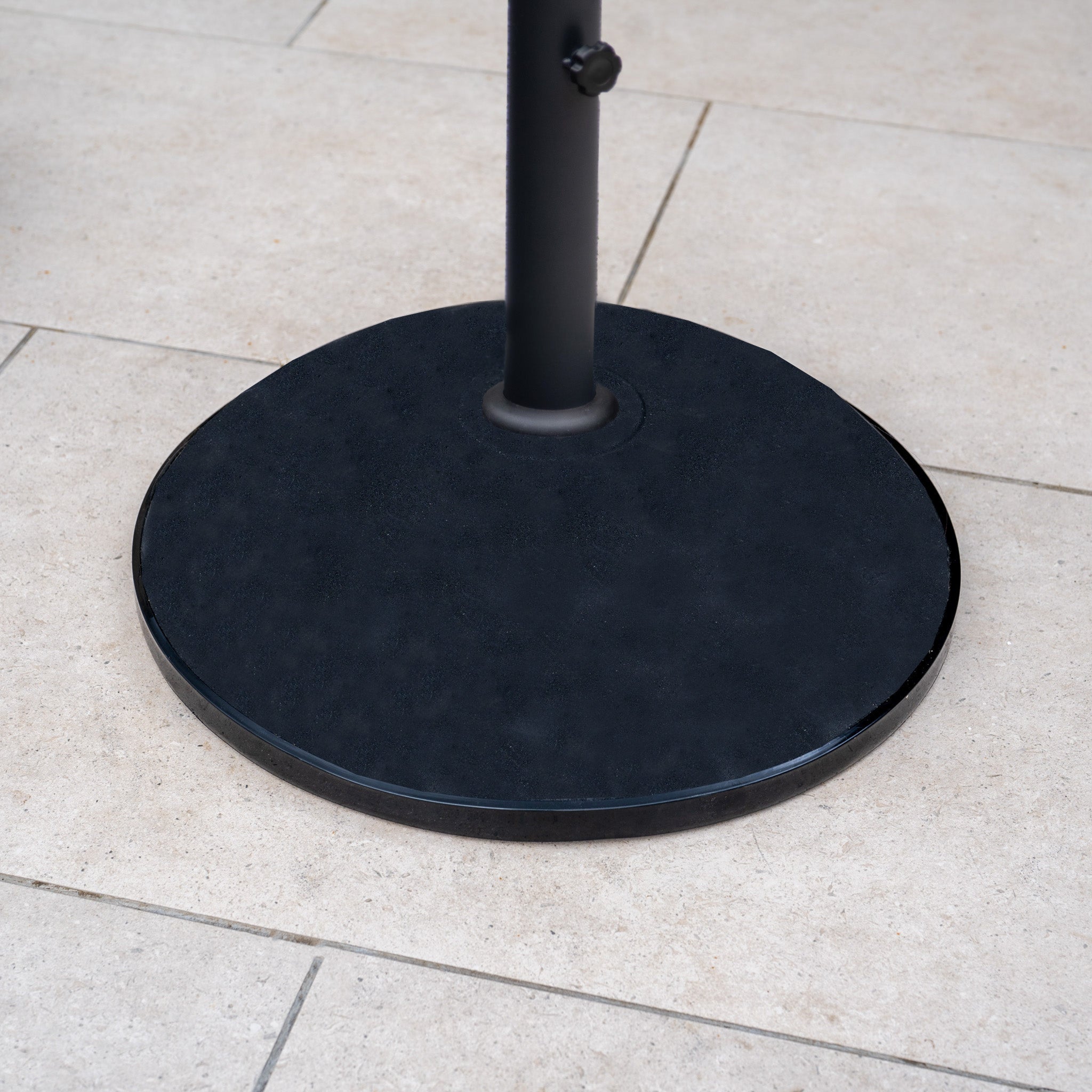 The 50kg Concrete Parasol Base with a round design sits on a light-colored tiled floor, providing reliable support for your outdoor umbrella.