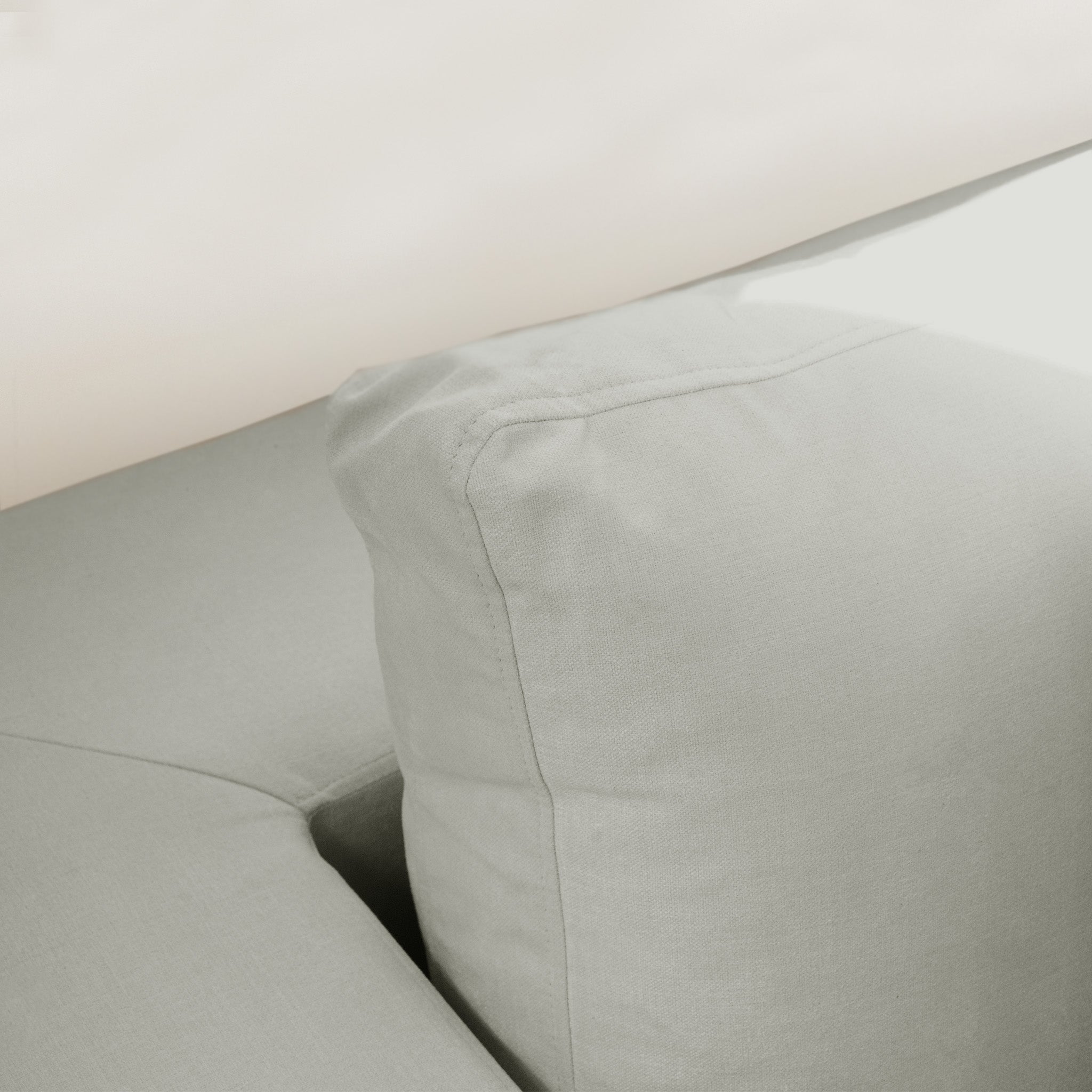 Close-up of a Hampshire Modular 2 Seat Sofa in Classic Grey cushion, featuring simple, smooth fabric, clean stitching, and plush duck feather and down filling.