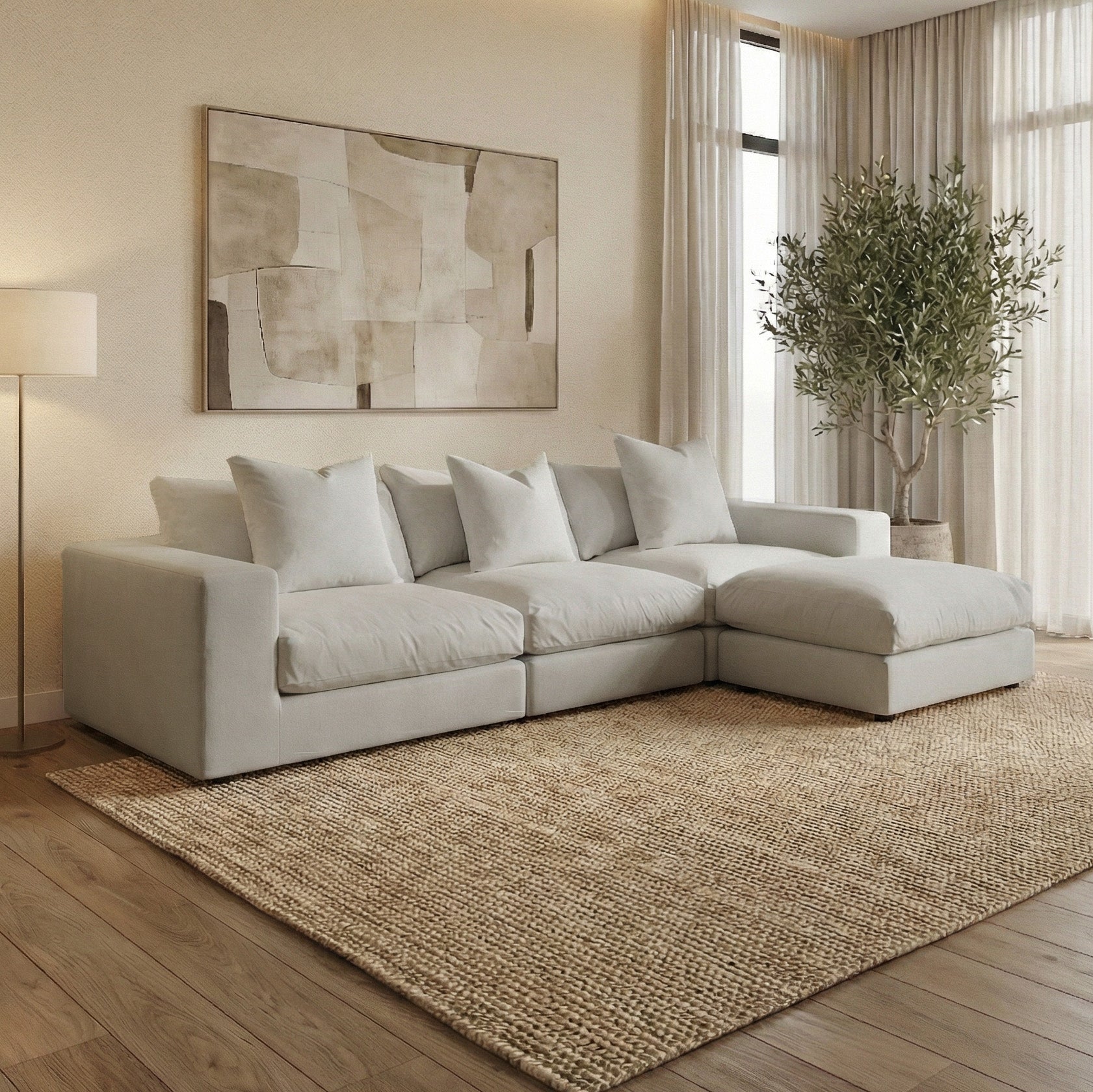 Modern living room featuring the Hampshire Modular 3 Seat Sofa in Classic Grey, a large rug, abstract wall art, floor lamp, and tall plant—all thoughtfully designed and handmade in England.