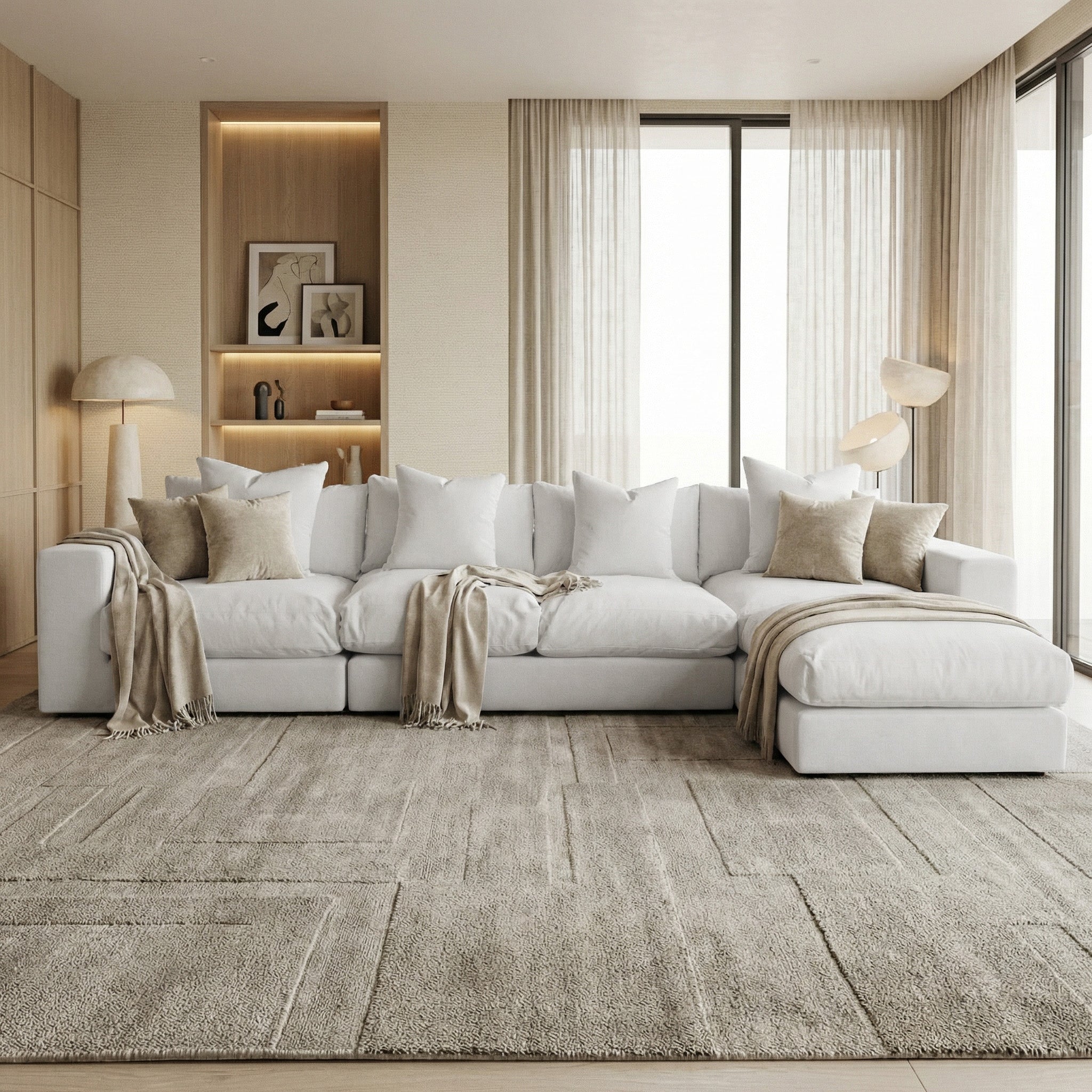 Modern living room featuring the Hampshire Modular 4 Seat Sofa in Dove Grey, handmade in England with duck feather cushions, neutral decor, and floor-to-ceiling windows adorned with sheer curtains.