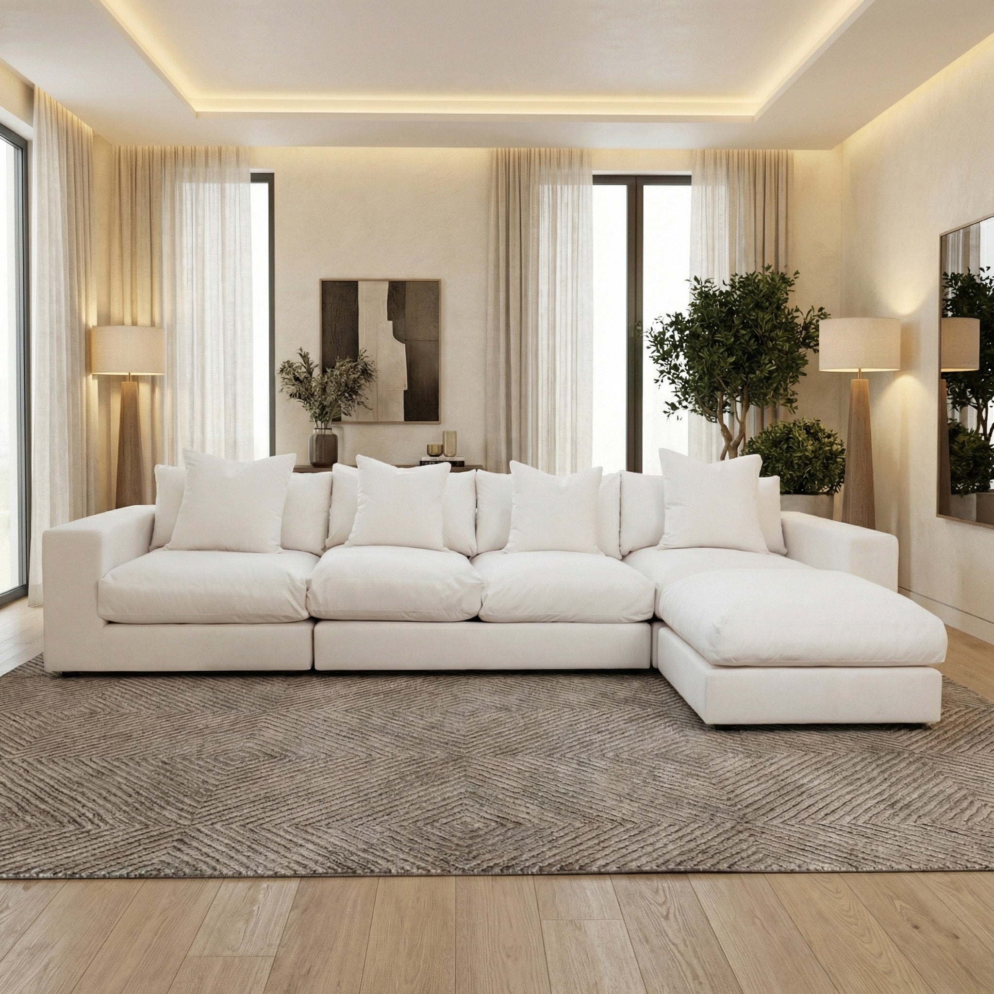 A modern living room with the Hampshire Modular 4 Seat Sofa in Ivory featuring duck feather cushions, neutral decor, and large windows with sheer curtains.