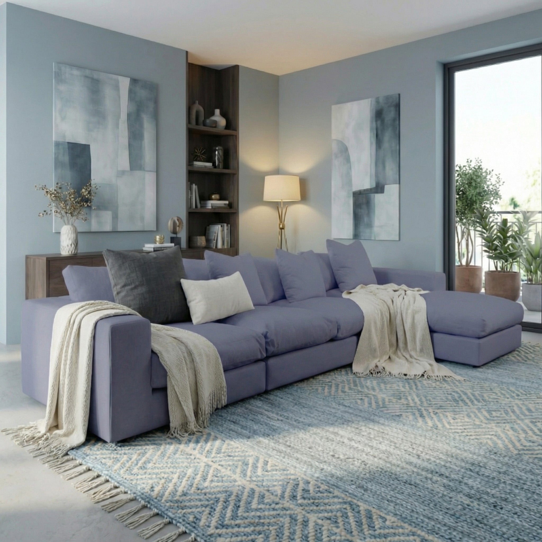 A modern living room with the Hampshire Modular 4 Seat Sofa in Midnight Blue, duck feather cushions, cozy throws, abstract art, and soft natural light.