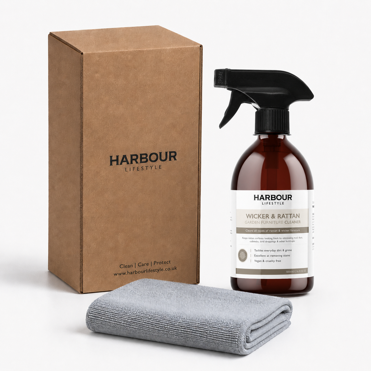 Brown box, spray bottle labeled “Wicker and Rattan Garden Furniture Cleaner,” and a folded gray cloth on a white background—an essential cleaning spray formulated to tackle stubborn dirt on your rattan garden furniture.