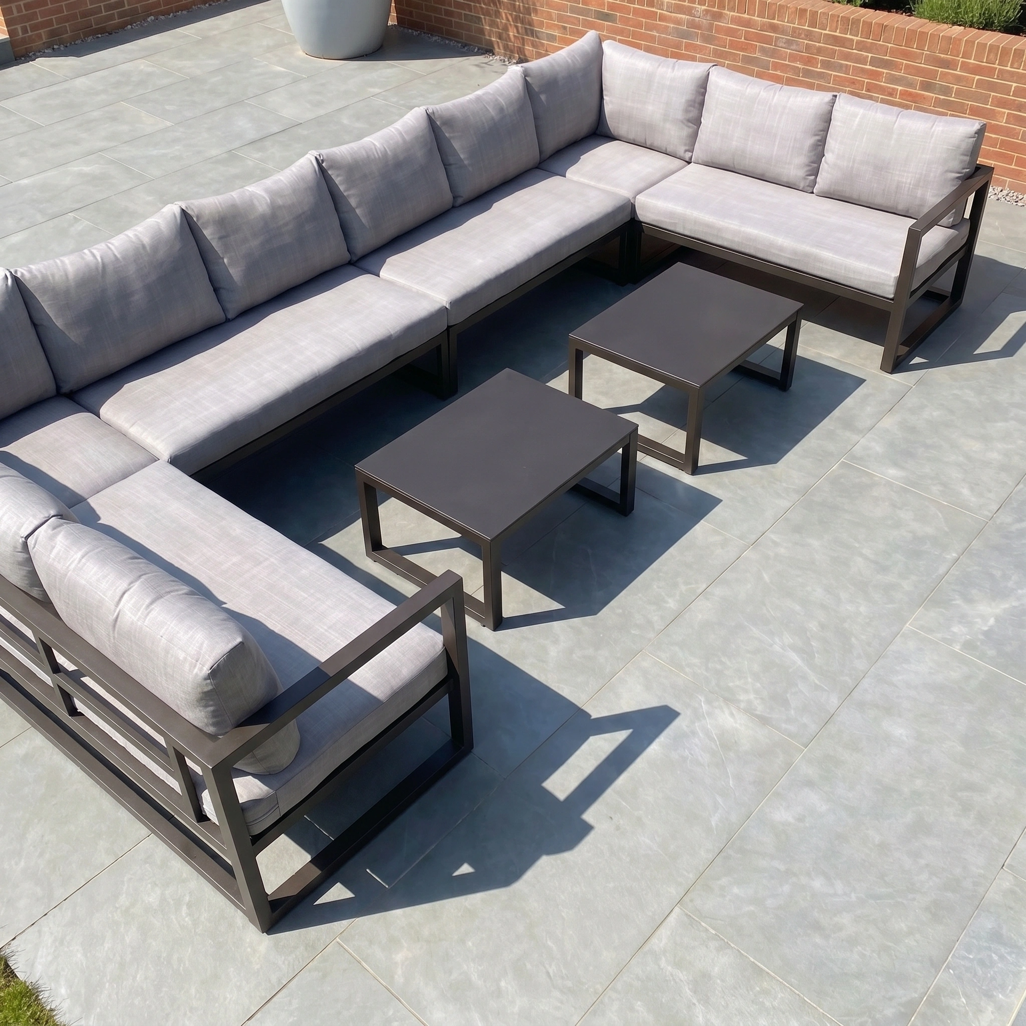 The Havana U-Shape Corner Group Set in washed grey features reclining seats, plush cushions, and three coffee tables for stylish, weather-resistant patio comfort—perfect for relaxing outdoors in modern elegance.
