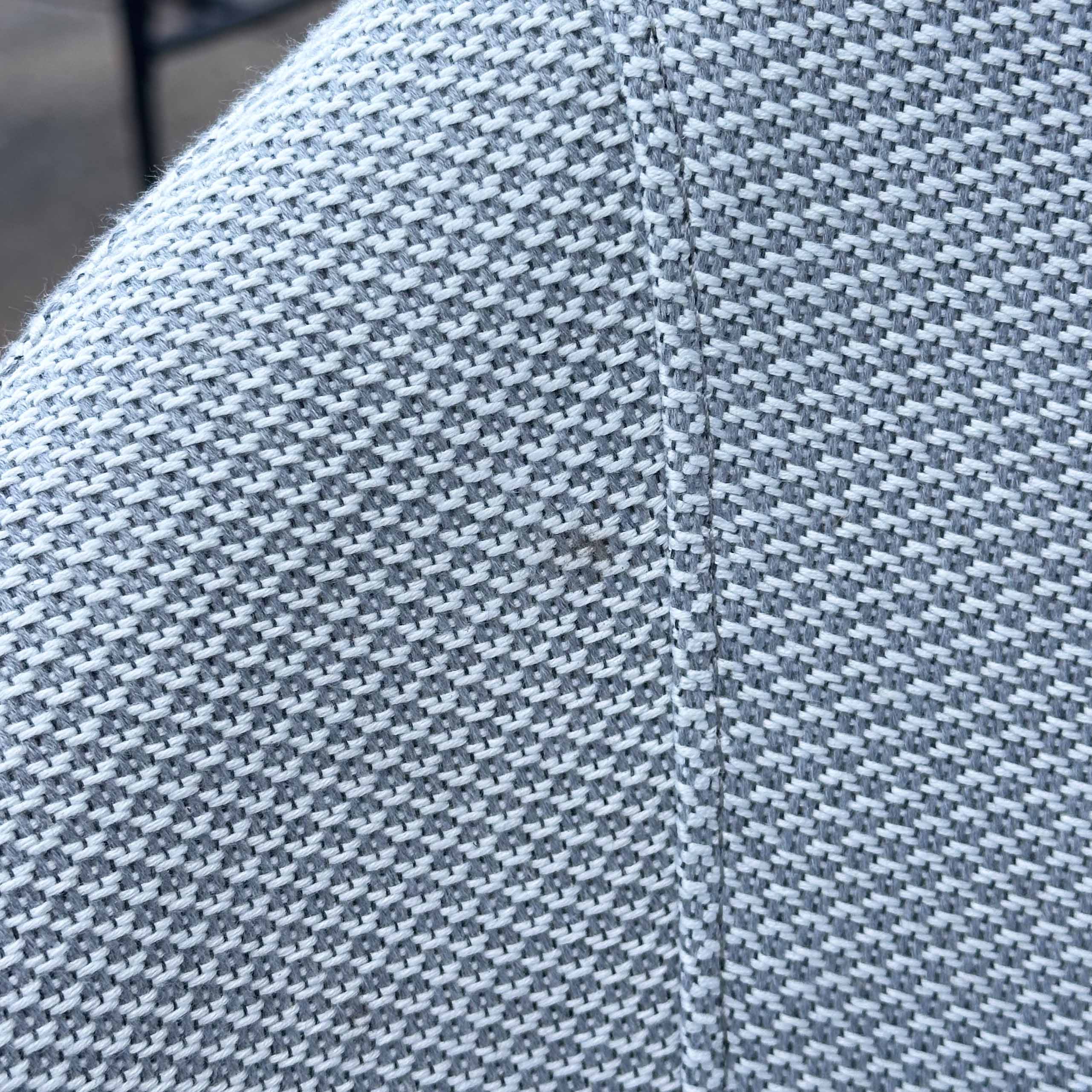 Close-up of Luna Outdoor Fabric Bar Stool in Oyster Grey (Ex Display), showing light gray solution-dyed acrylic with a small dark stain near the center.