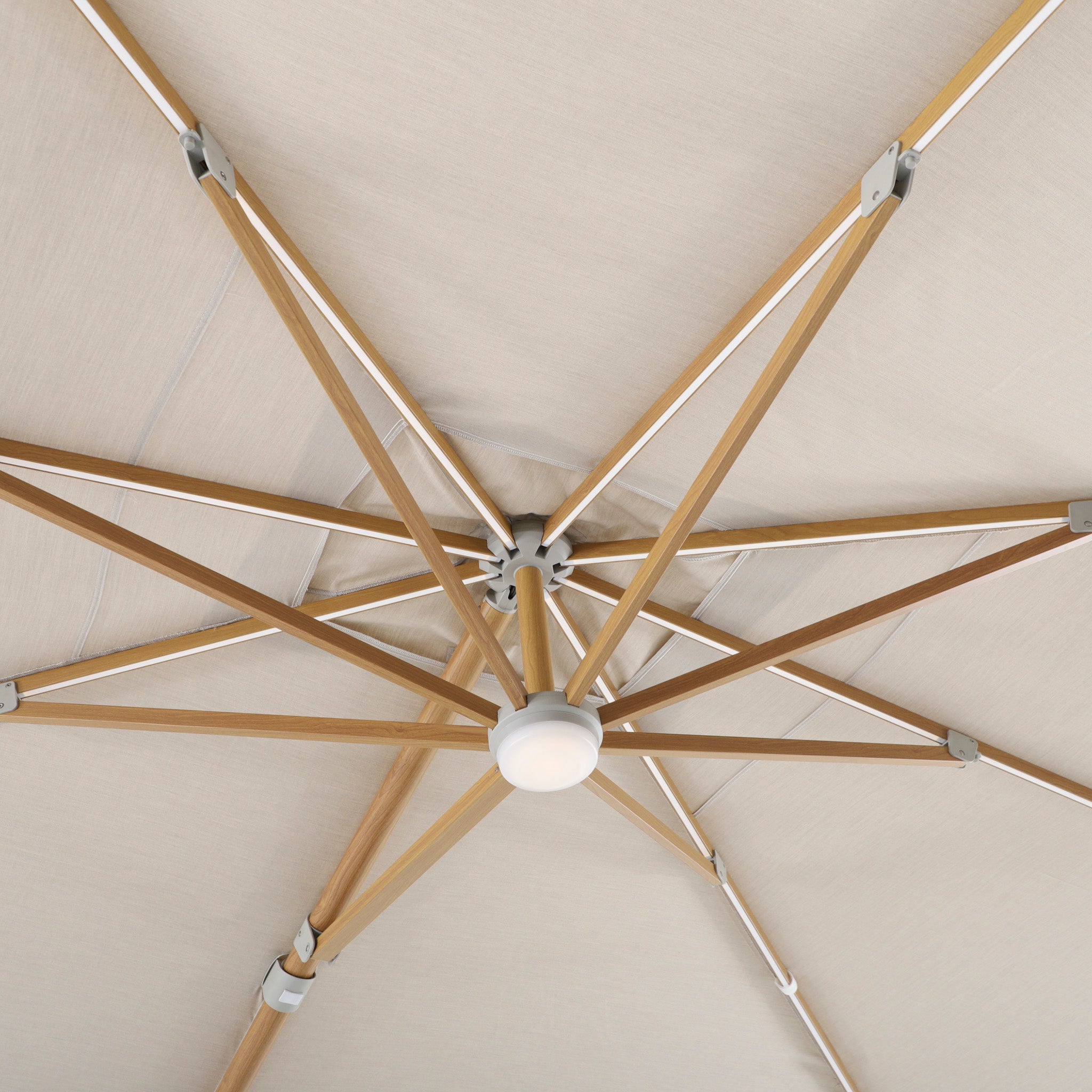 View from below of the Volos 3m x 4m Rectangular Cantilever Parasol in Wheat and Wood Effect, featuring UV-resistant canopy, wooden-effect ribs, LED lighting, and a 120kg granite base.