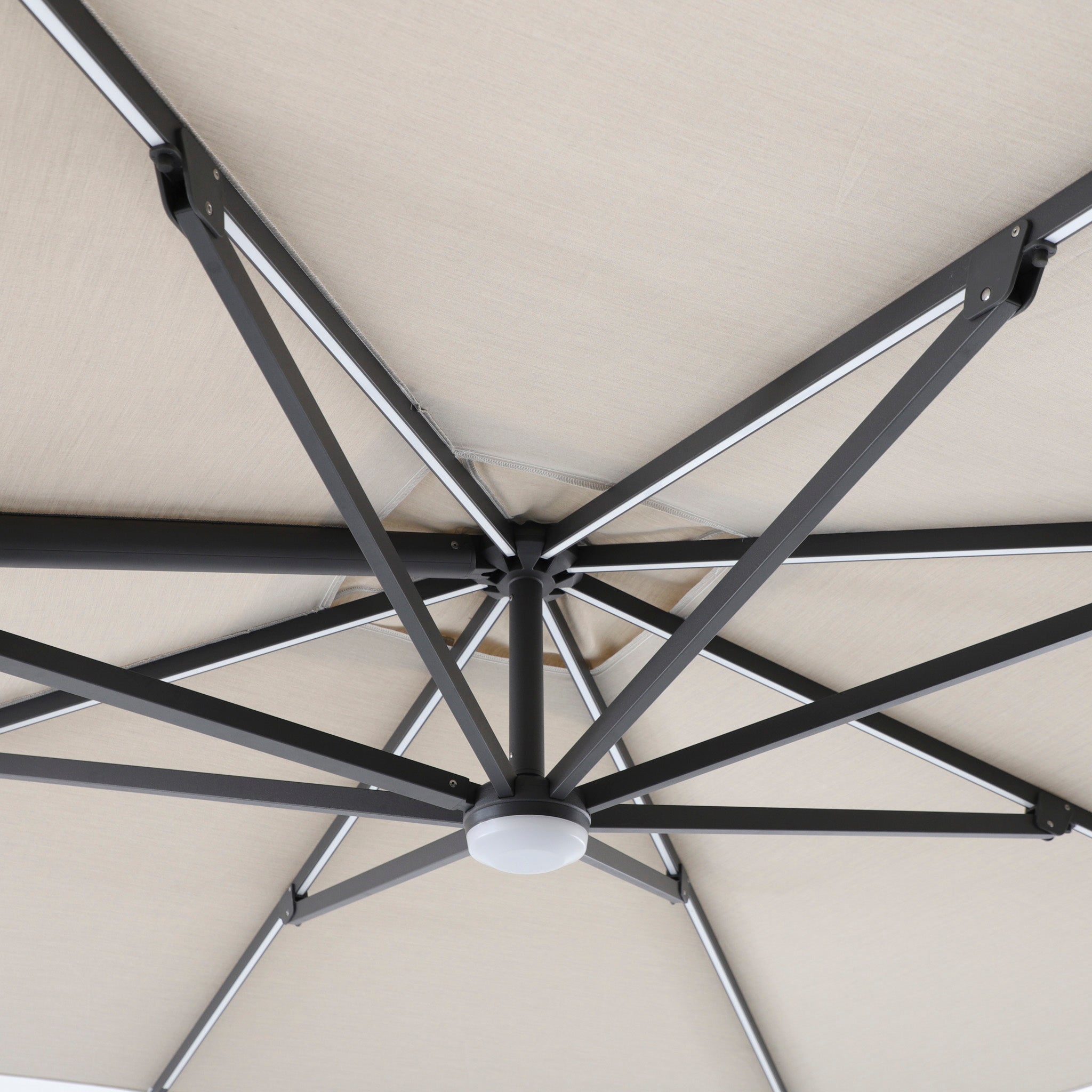 Close-up of the Volos 3m x 3m Square Cantilever Parasol in Wheat, highlighting its sturdy metal support ribs, central hub, UV resistant canopy, built-in LED lighting, and 120kg granite base.