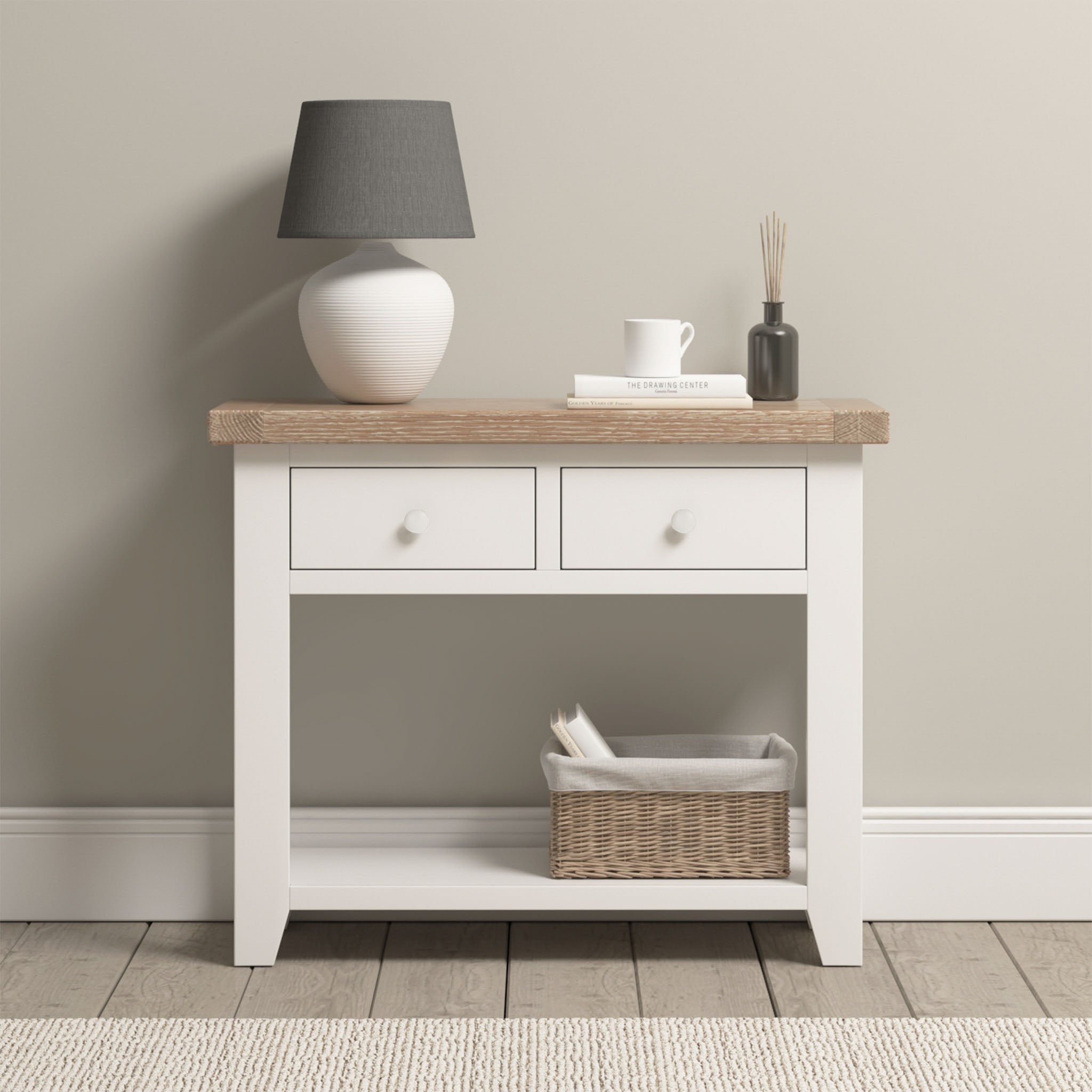 The Burford 2 Drawers Console Table in Warm White adds style and function to your space, featuring storage with two drawers and room underneath for décor or baskets.