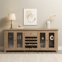 The Burford Grand Sideboard with Wine Rack in Natural Oak, paired with glass doors, a stylish lamp, and abstract wall art, brings modern flair to a neutral room.