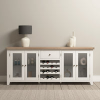 Burford Grand Sideboard with Wine Rack in Warm White, displayed against a beige wall on a wooden floor.