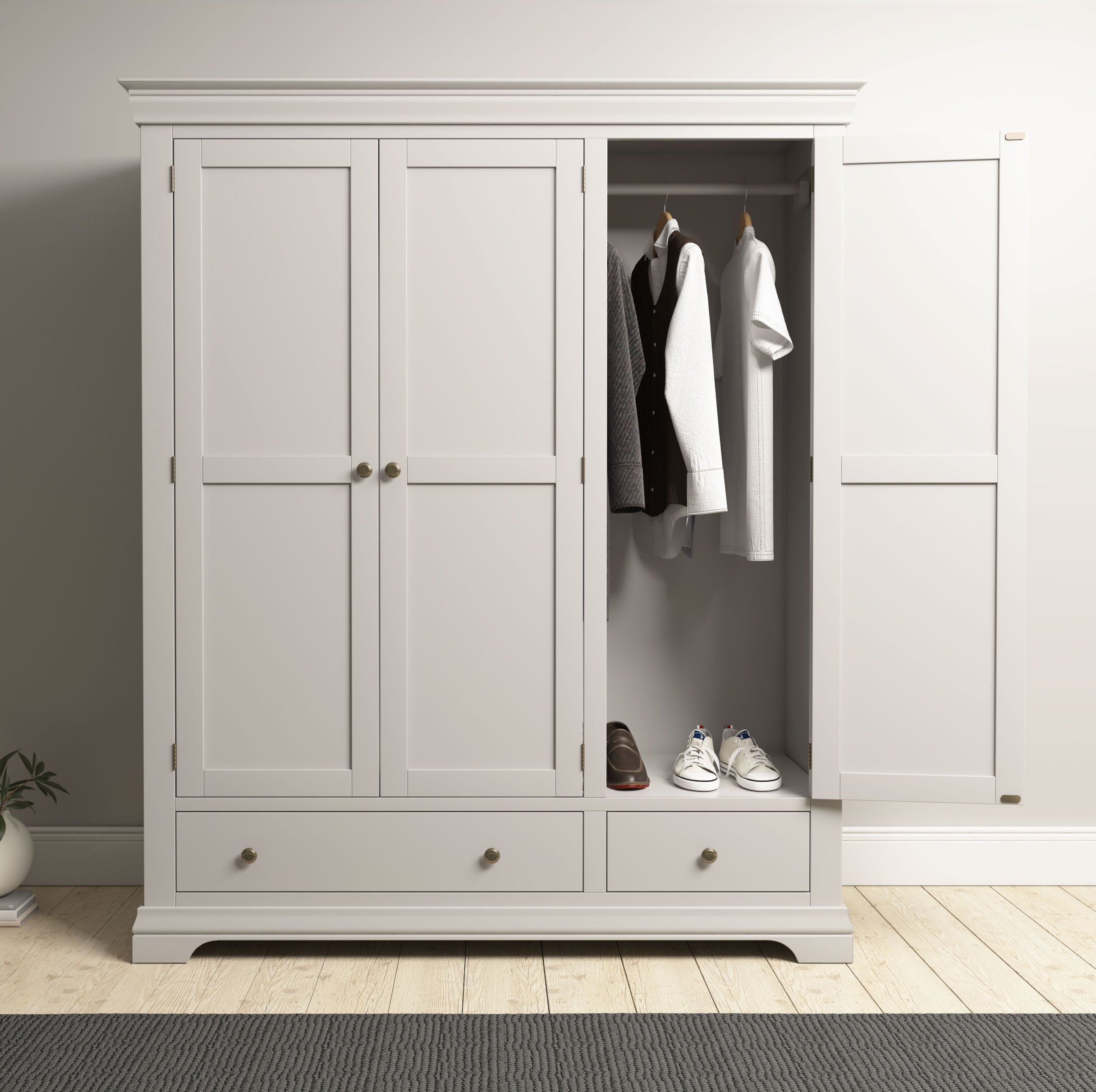 The Chalbury Triple Wardrobe in Pebble Grey with open doors displays hanging clothes, shoes inside, and drawers below—a perfect bedroom storage solution.