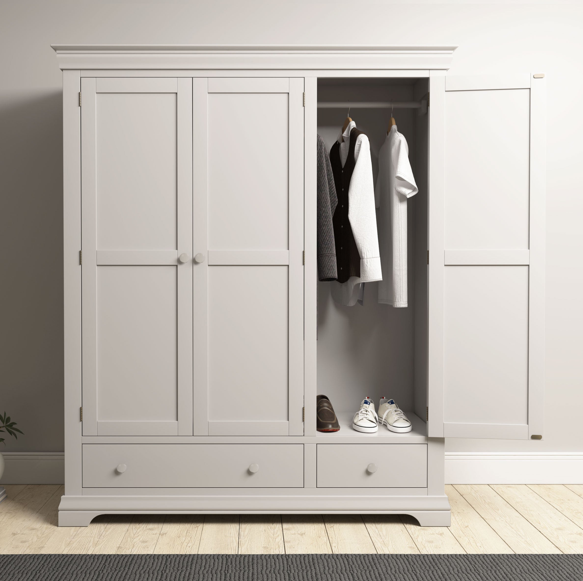 The Chalbury Triple Wardrobe in Pebble Grey provides spacious bedroom storage with three doors, making it easy to organize clothes and shoes neatly inside.