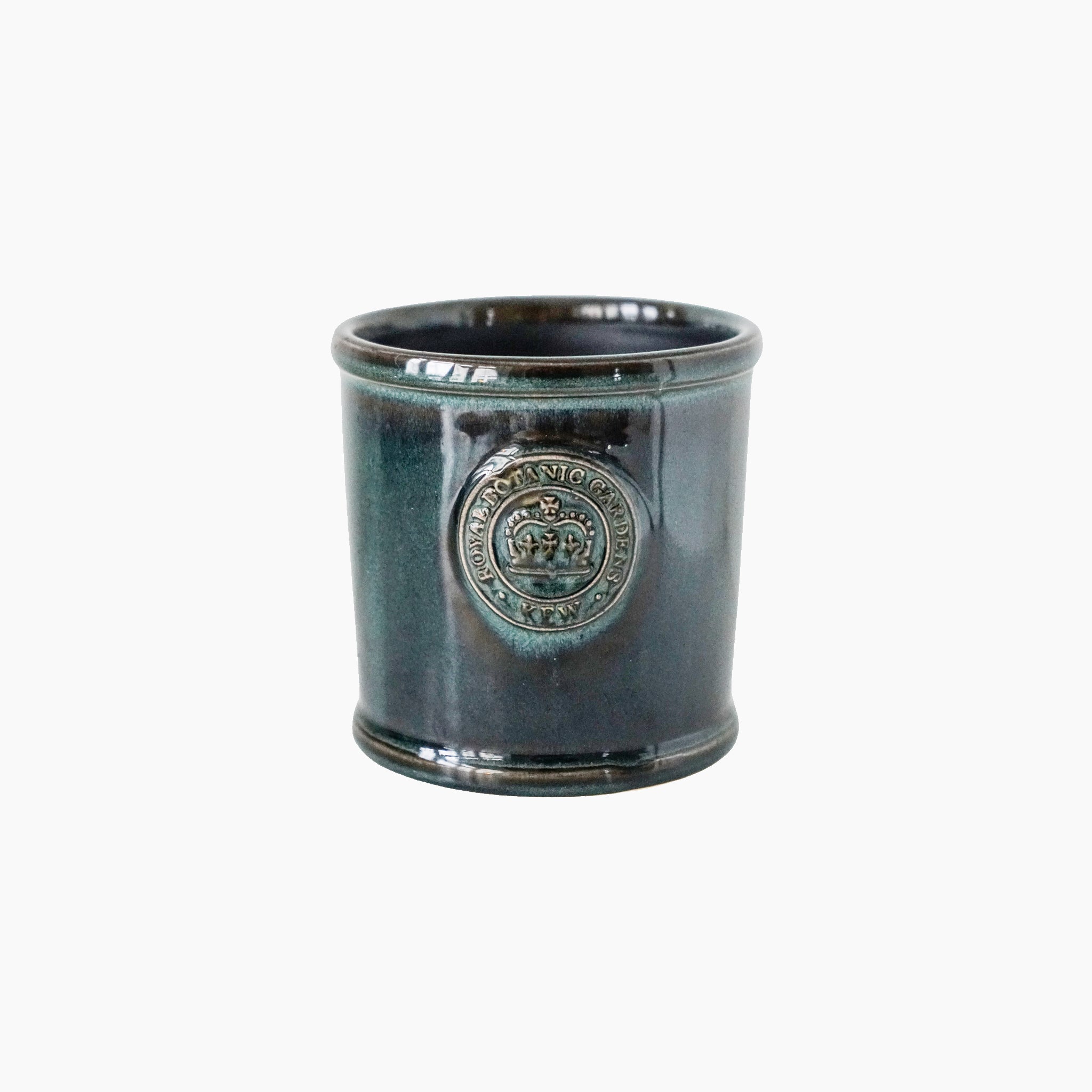 The Ivyline - Kew Reactive Glaze Emerald Planter is a green ceramic houseplant pot with a round embossed emblem and a stunning reactive glaze, set against a plain white background, reminiscent of collections at Kew Gardens.