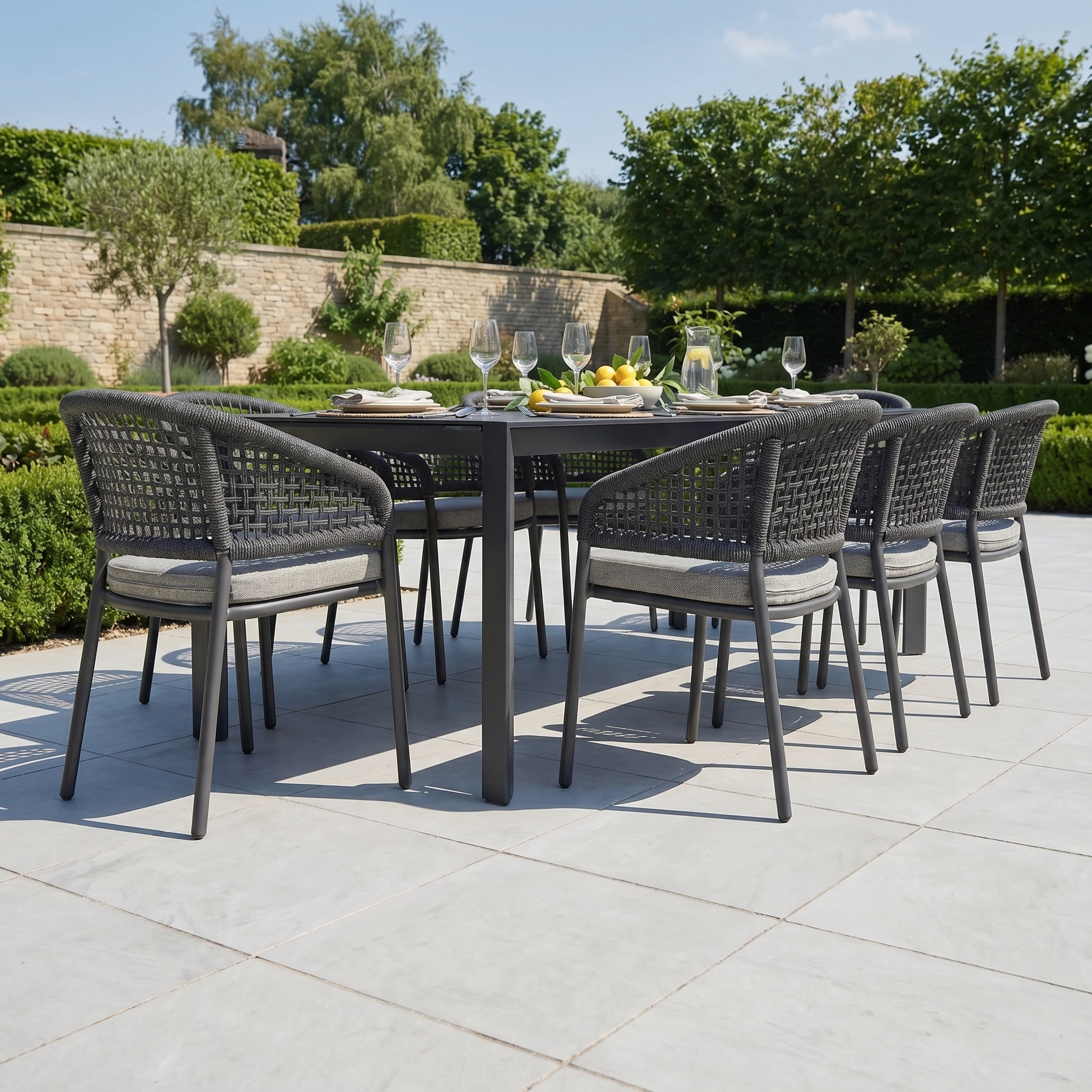 The Kalama 8 Seat Extending Dining Set with Ceramic Table in Truffle features stylish woven chairs and a sleek ceramic-top table, ideal for elegant alfresco dining.