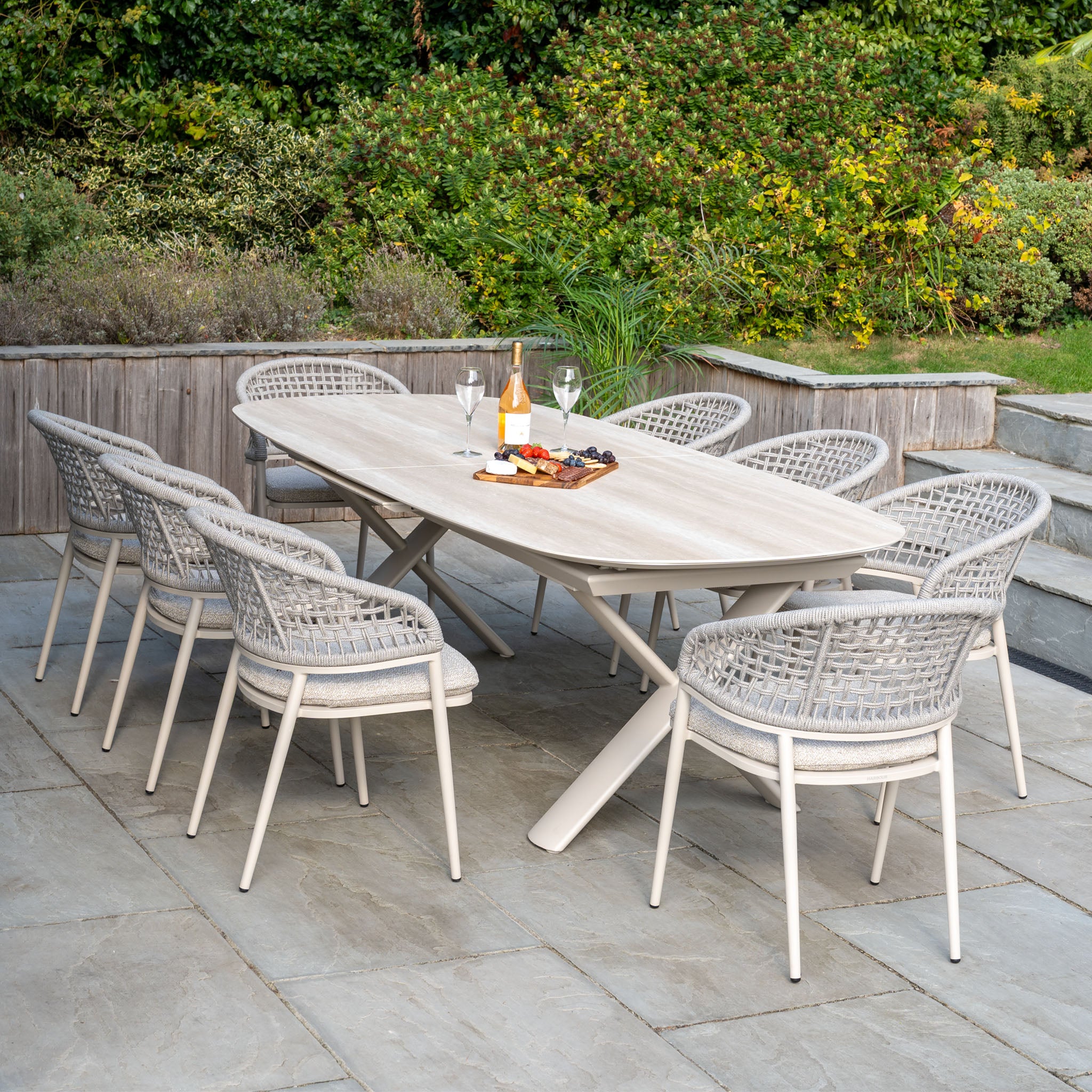 Outdoor dining set with eight woven chairs and an Albatross Extending Table in Oatmeal—perfect for gatherings with the Kalama 8 Seat Oval Rope Dining Set.