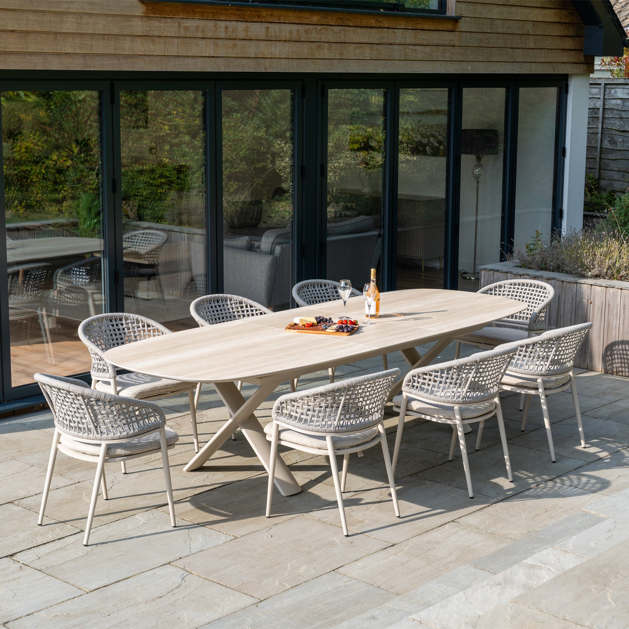 Enjoy outdoor dining with the Kalama 8 Seat Oval Rope Dining Set with Albatross Extending Table in Oatmeal—perfect for gatherings and relaxing evenings on your patio.