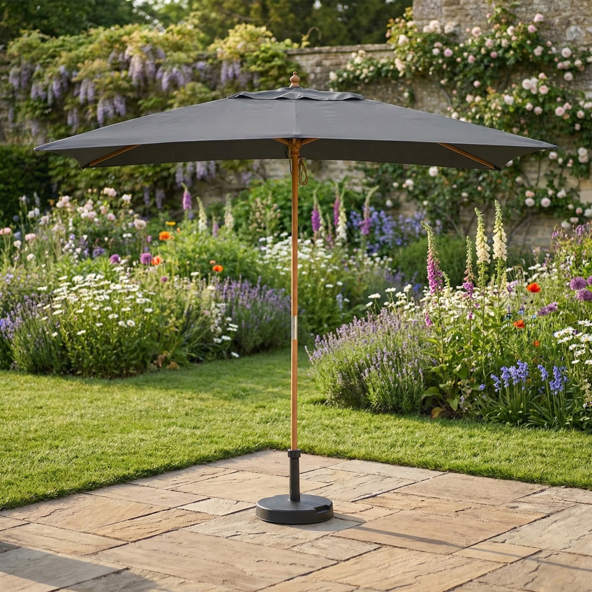 The Kratos 3m x 2m Rectangular Wooden Parasol in Grey features a sturdy pole and adds stylish sun protection to any lush garden.