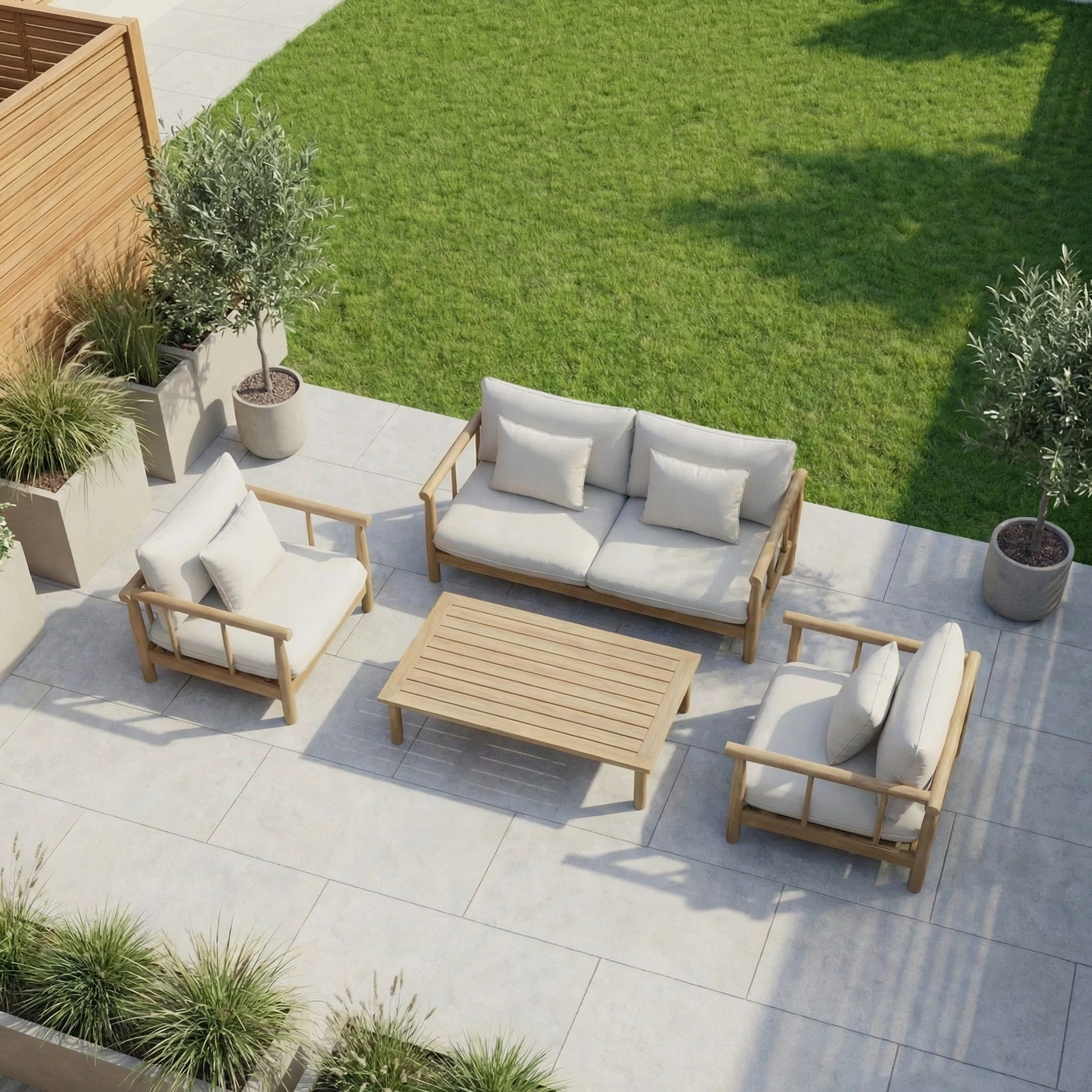 The Lavenham 2 Seat Sofa Set in Linen features wooden sofas, chairs, and a table crafted from sustainably sourced eucalyptus wood, set on a tiled surface surrounded by greenery and potted plants.