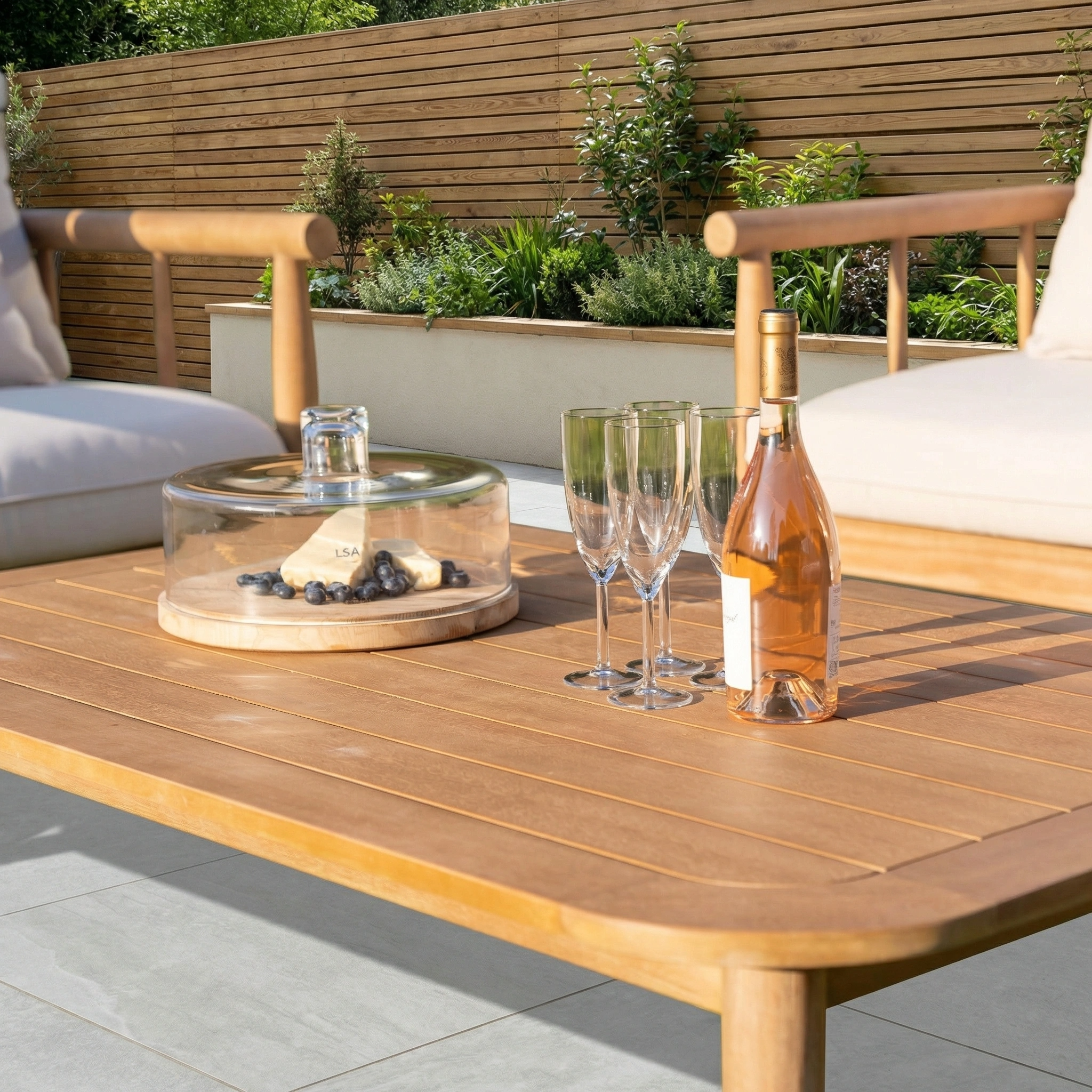 The Lavenham 2 Seat Sofa Set in Linen creates a cozy outdoor lounge, perfect for relaxing with wine and cheese, surrounded by lush garden views. Crafted as elegant patio seating, it's ideal for your garden retreat.