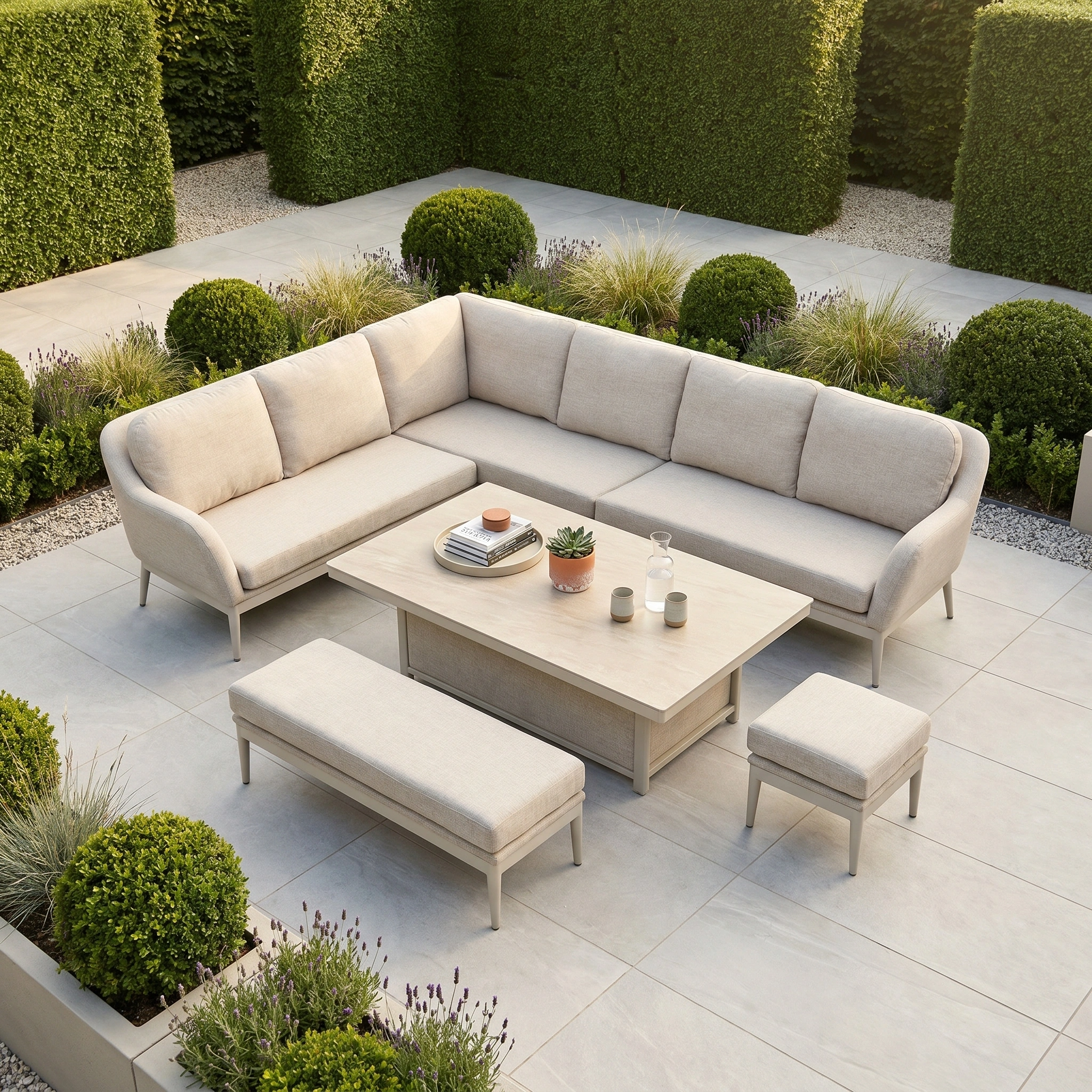 Modern outdoor patio with greenery and light stone tiles, featuring the Luna Outdoor Fabric Rectangular Corner Dining Set with Rising Table in Fawn (Left Hand), crafted from all-weather material for lasting comfort and durability.