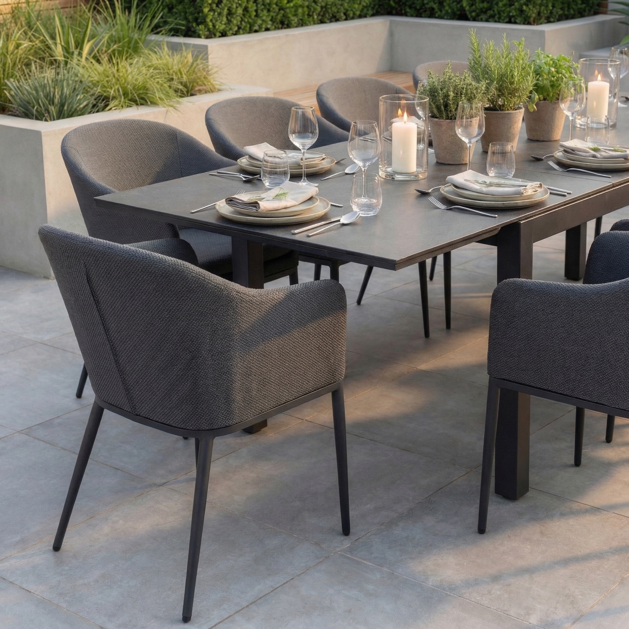 The Luna 10 Seat Outdoor Fabric Extending Ceramic Dining Set in Grey features stylish gray chairs and a chic ceramic table, ideal for elegant all-weather dining on your patio.