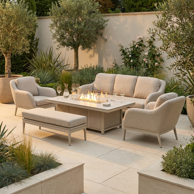 Modern outdoor patio featuring the Luna 3 Seat Outdoor Fabric Sofa Set with Rising Firepit Table in Fawn, surrounded by lush greenery.