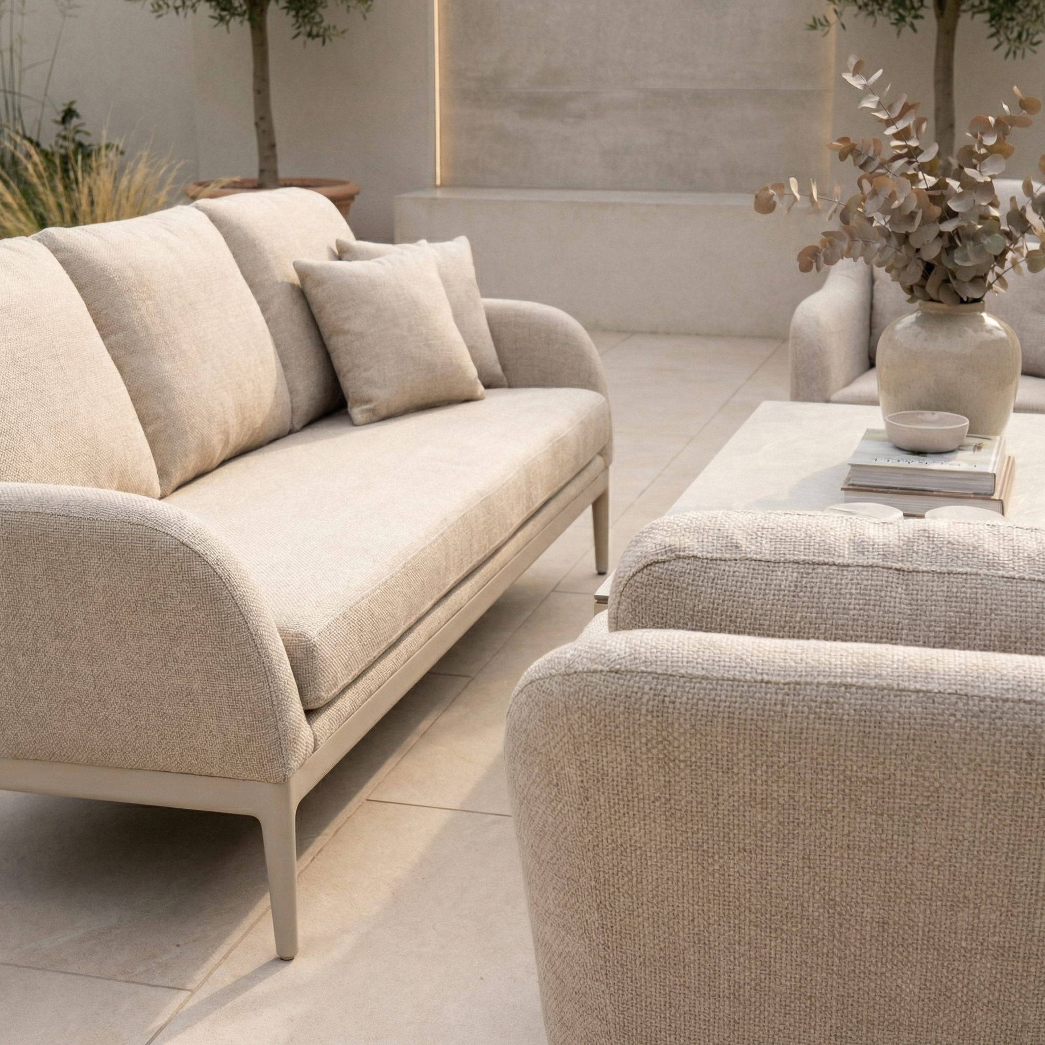 The Luna 3 Seat Outdoor Fabric Sofa Set with Rising Table in Fawn features cushions and a coffee table—ideal all-weather outdoor furniture for relaxing outside.