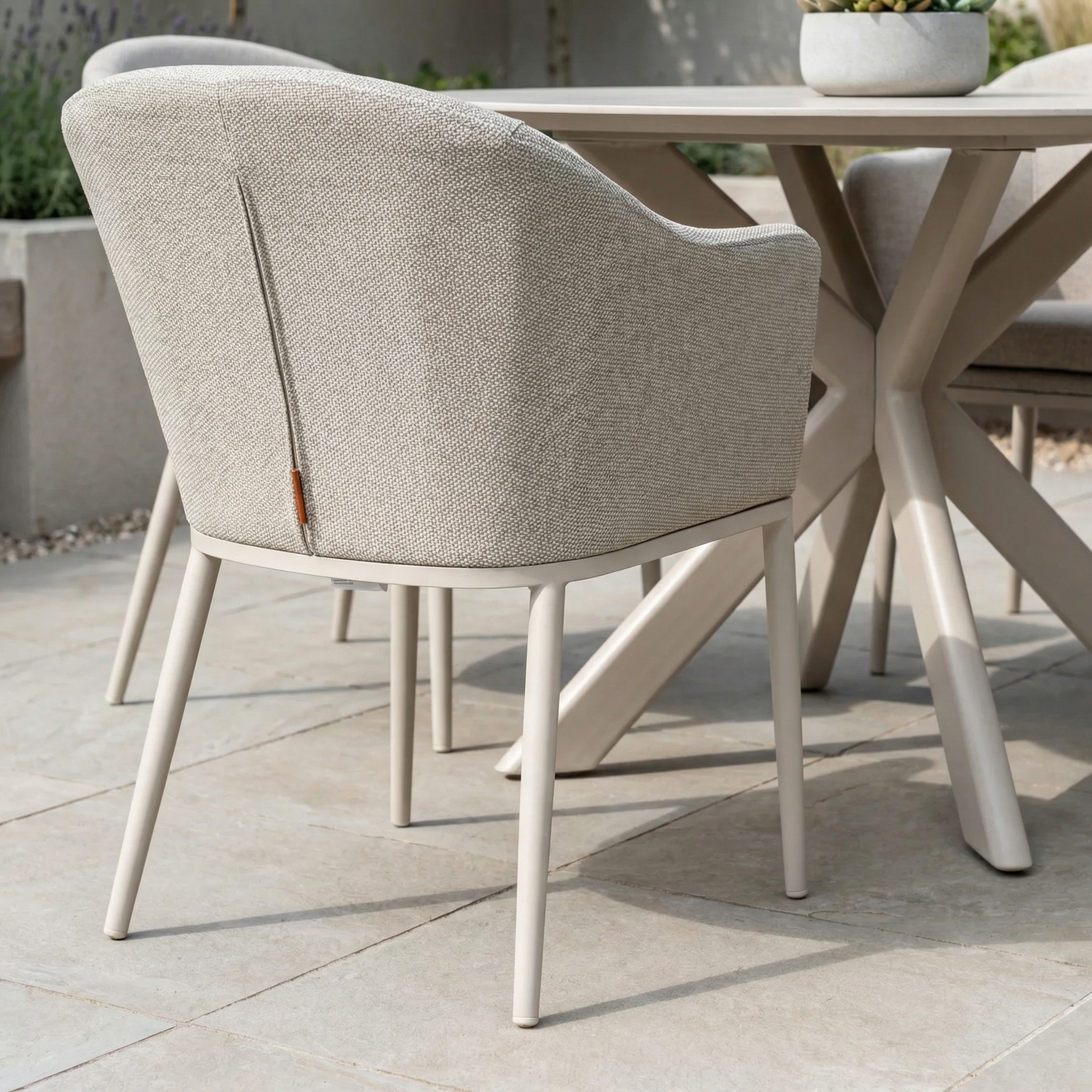 The Luna 4 Seat Round Outdoor Fabric Dining Set with Albatross Table in Fawn creates an inviting all-weather dining area on your patio, combining comfort and style for memorable outdoor gatherings.