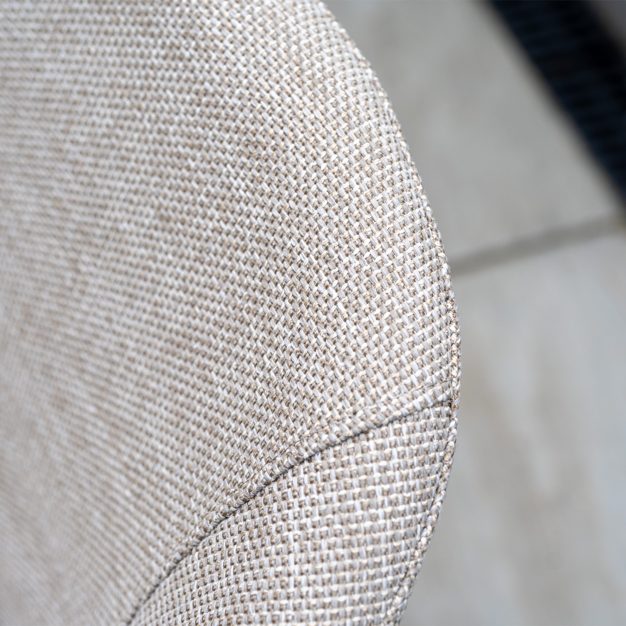 Close-up of the Luna 4 Seat Round Outdoor Fabric Dining Set with Albatross Table in Fawn, featuring beige textured upholstery and visible stitching, designed for all-weather outdoor use.