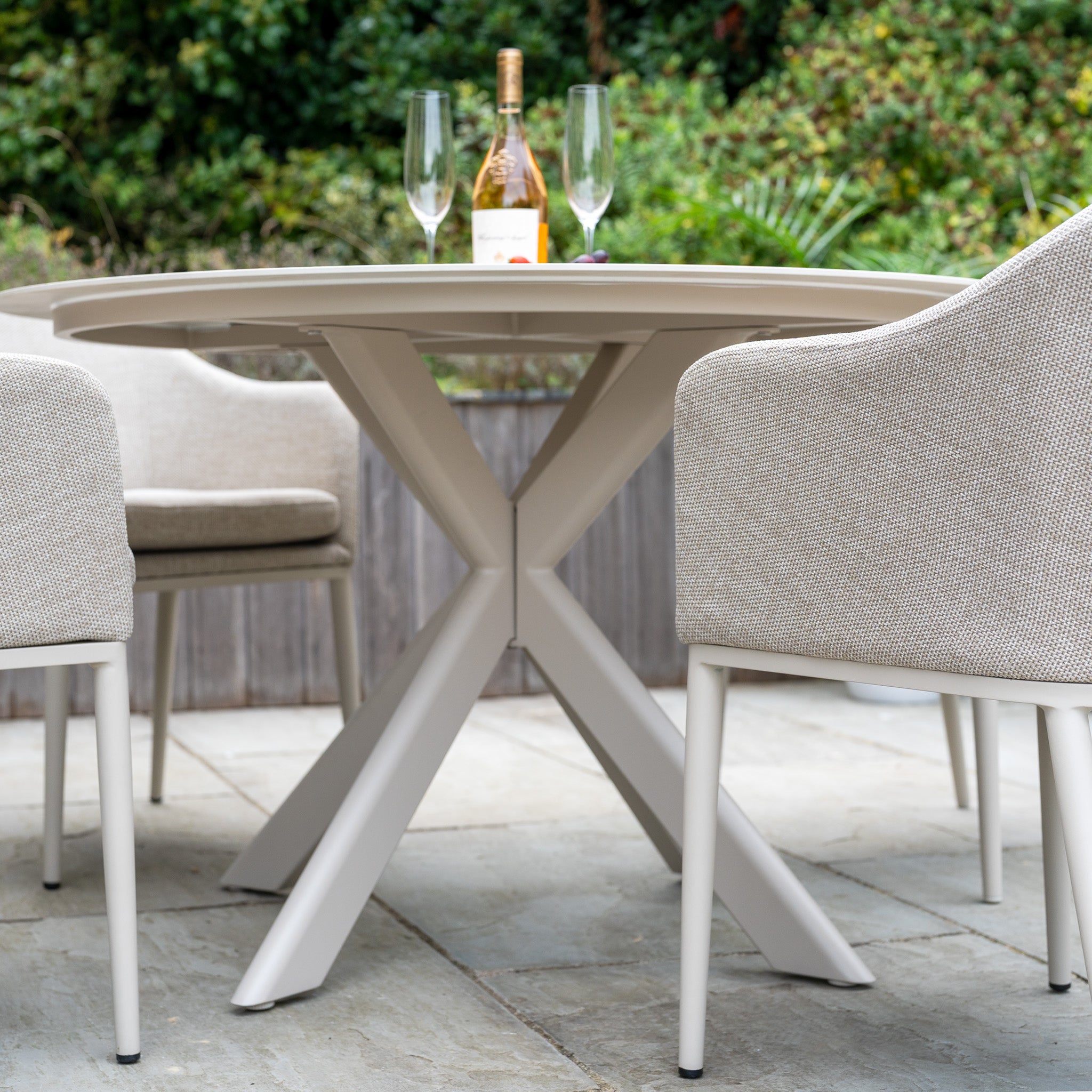 The Luna 4 Seat Round Outdoor Fabric Dining Set with Albatross Table in Fawn features a ceramic dining table and cushioned chairs in durable fabric—perfect for stylish, all-weather alfresco gatherings.
