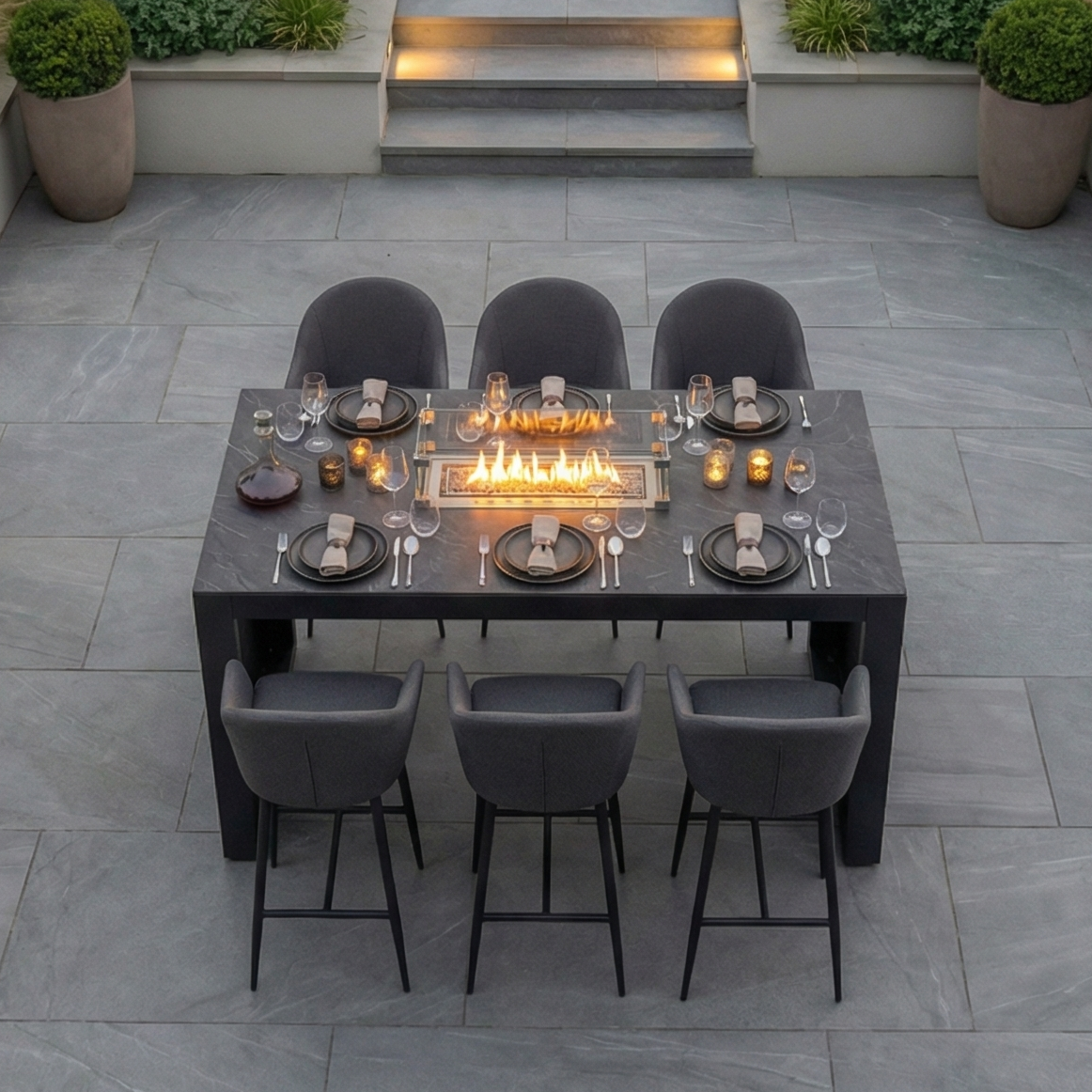 The Luna 6 Seat Outdoor Fabric Ceramic Firepit Bar Set in Grey features a built-in firepit, all-weather grey chairs, and comes with elegant place settings.
