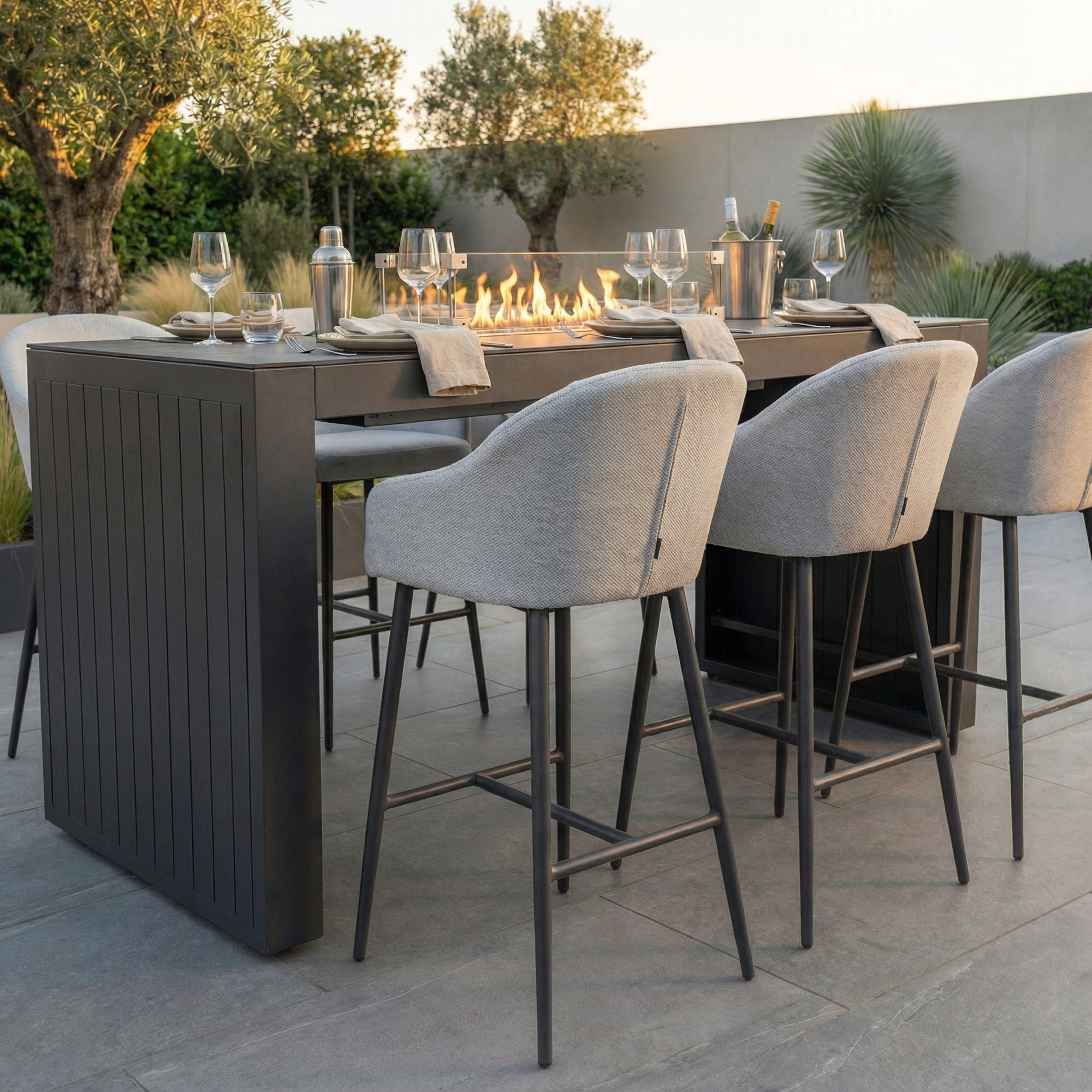 The Luna 6 Seat Outdoor Fabric Ceramic Firepit Bar Set in Oyster Grey features cushioned chairs with durable, all-weather Luna fabric and a stylish dining table with a built-in firepit for comfort and lasting outdoor style.
