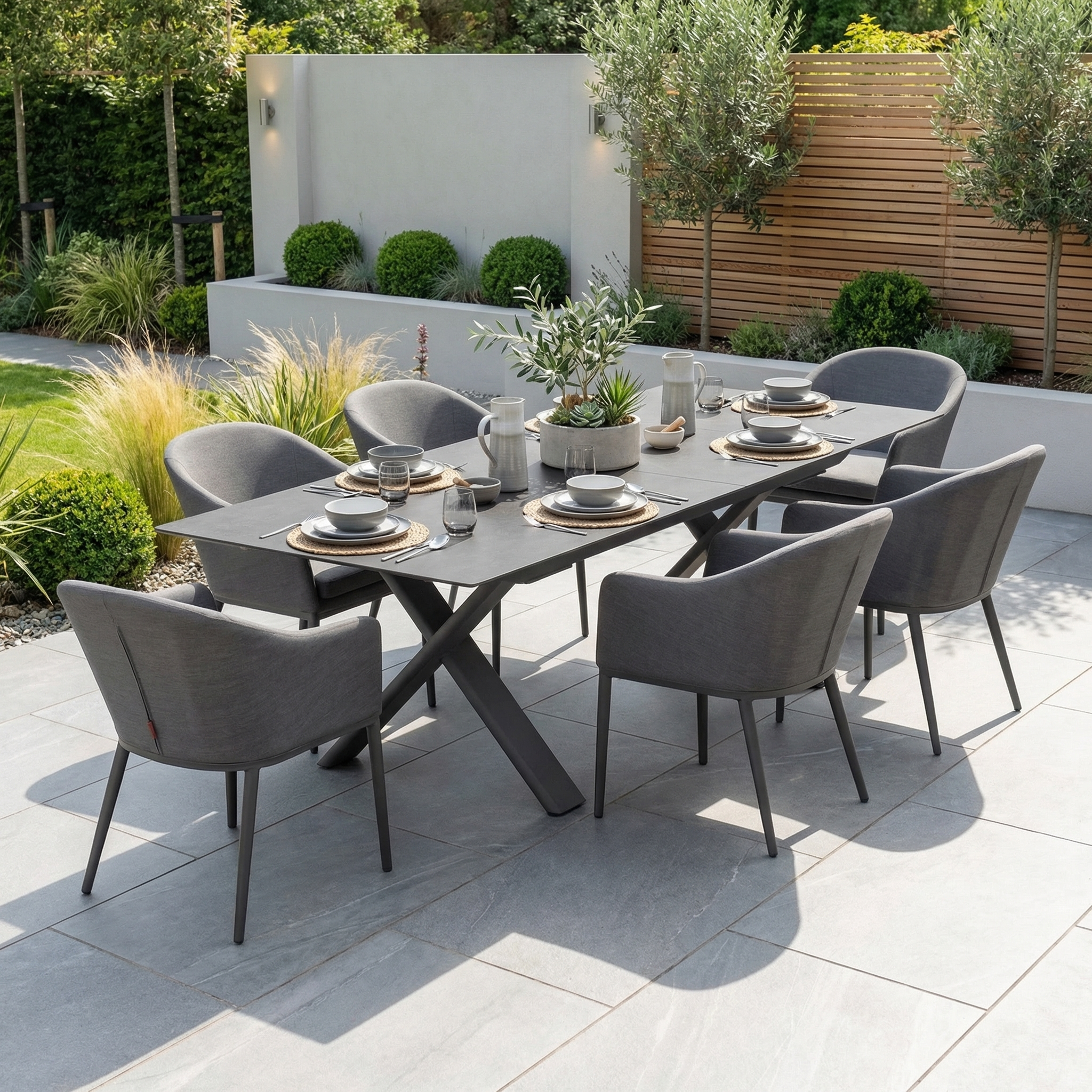 The Luna 6 Seat Outdoor Fabric Dining Set with Albatross Extending Table in Grey offers durable all-weather comfort and style, featuring six gray chairs and a spacious table—perfect for garden patios year-round.