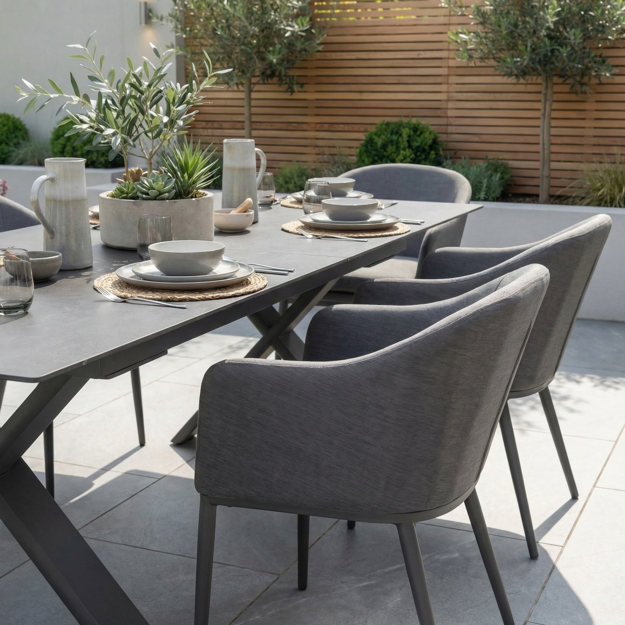 The Luna 6 Seat Outdoor Fabric Dining Set with Albatross Extending Table in Grey creates a stylish patio, with all-weather chairs perfect for outdoor dining.