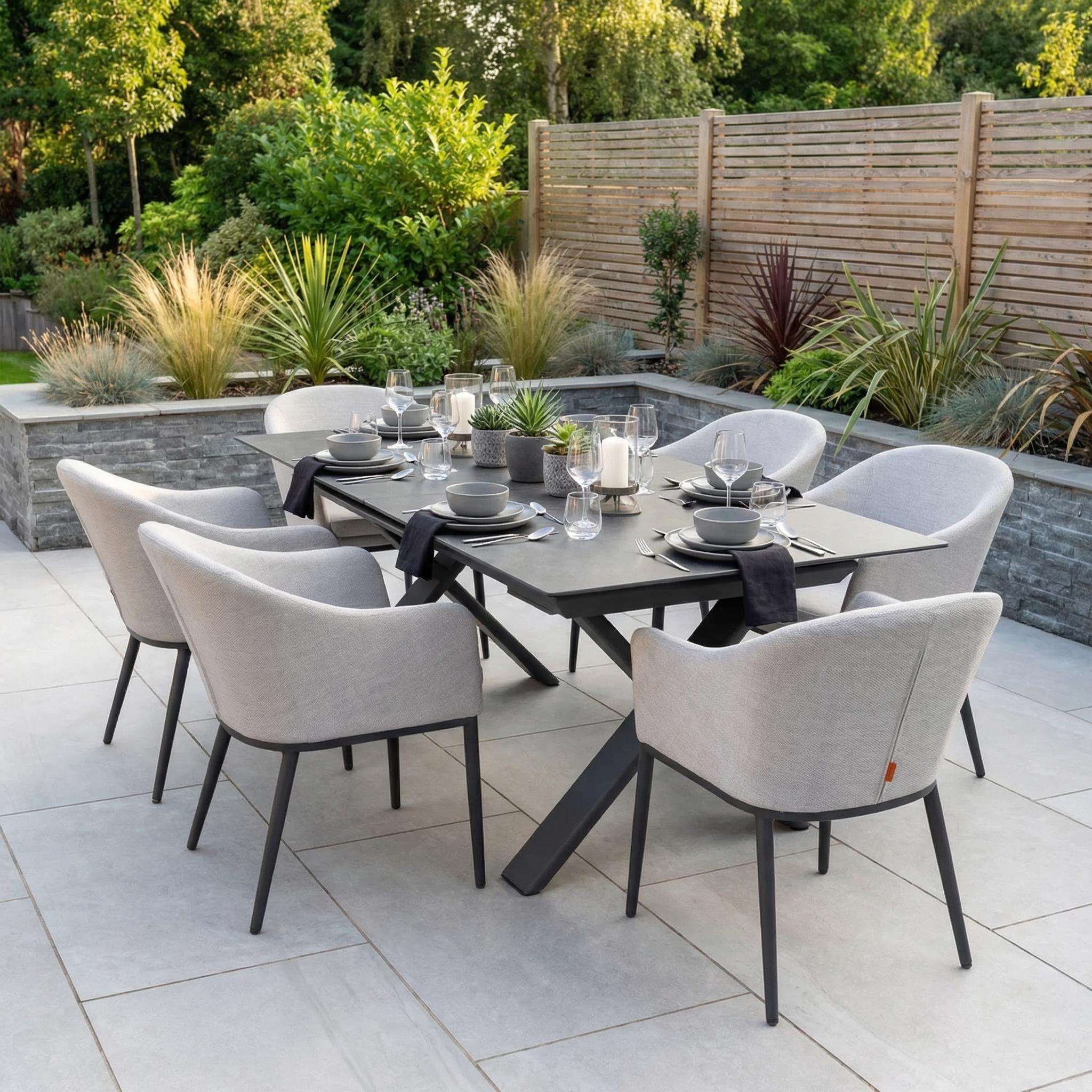 The Luna 6 Seat Outdoor Fabric Dining Set with Albatross Extending Table in Oyster Grey offers modern, all-weather patio dining with a stylish look—ideal for entertaining outdoors amid your garden.