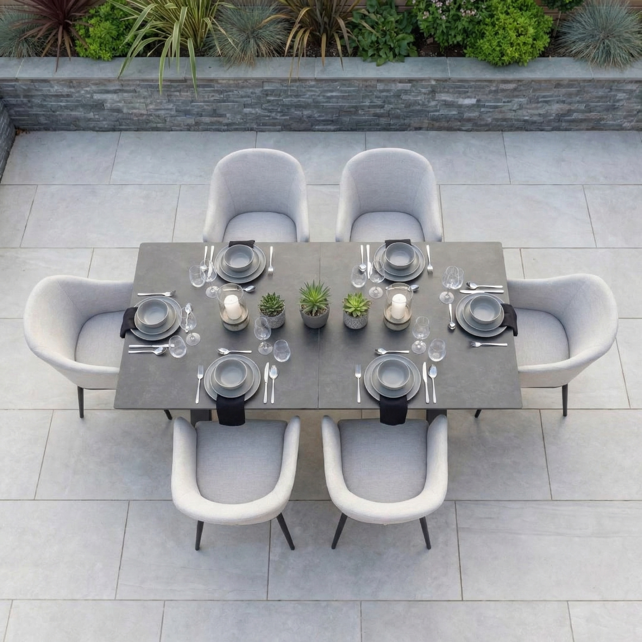 The Luna 6 Seat Outdoor Fabric Dining Set features an Albatross extending table in Oyster Grey and weather-resistant chairs, ideal for stylish outdoor dining.