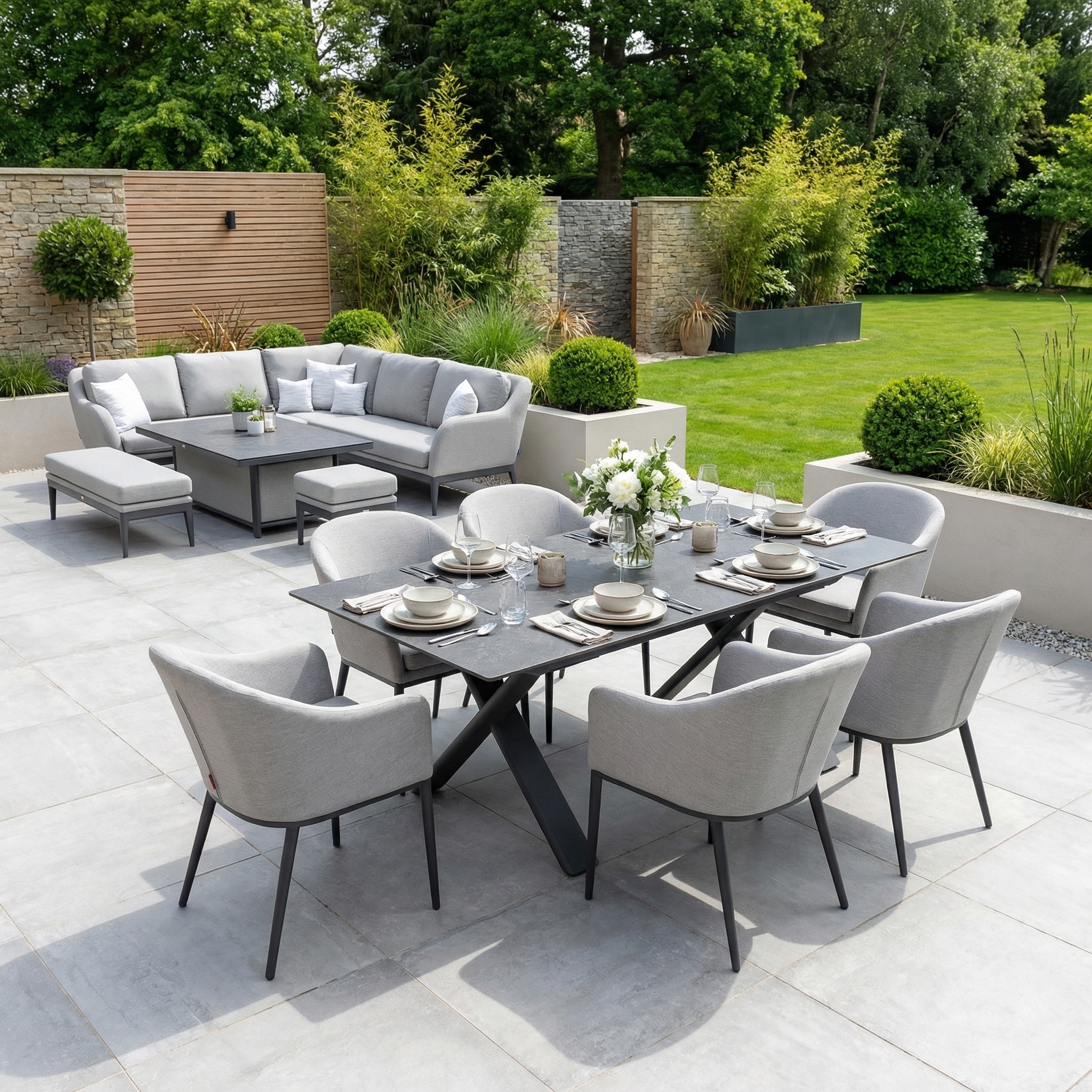 The Luna 6 Seat Outdoor Fabric Dining Set with Albatross Extending Table in Oyster Grey creates a stylish and functional all-weather seating area on your patio.