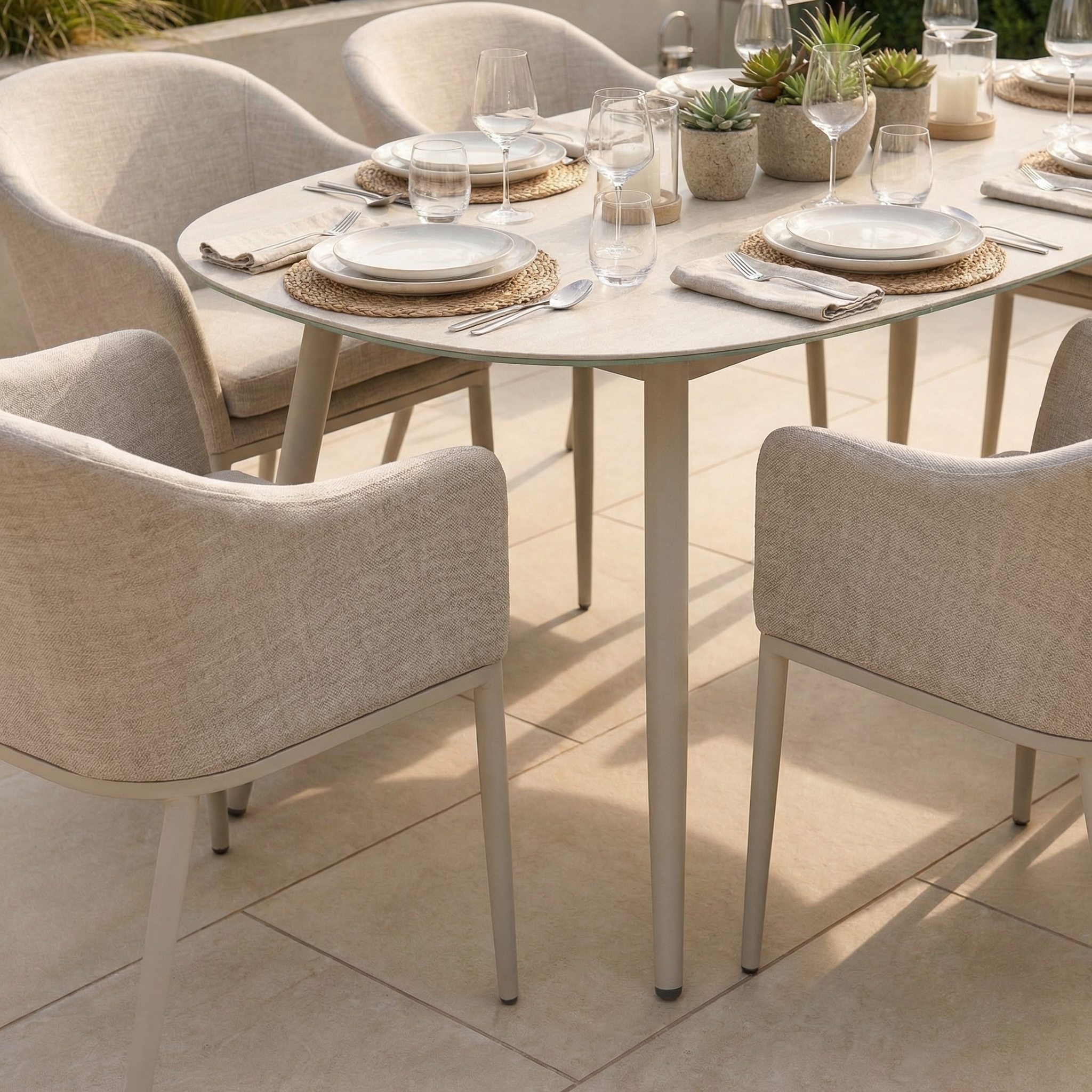 The Luna 6 Seat Outdoor Fabric Oval Ceramic Dining Set in Fawn features light beige all-weather chairs and a pale stone ceramic table, perfect for stylish outdoor entertaining and long-lasting durability.