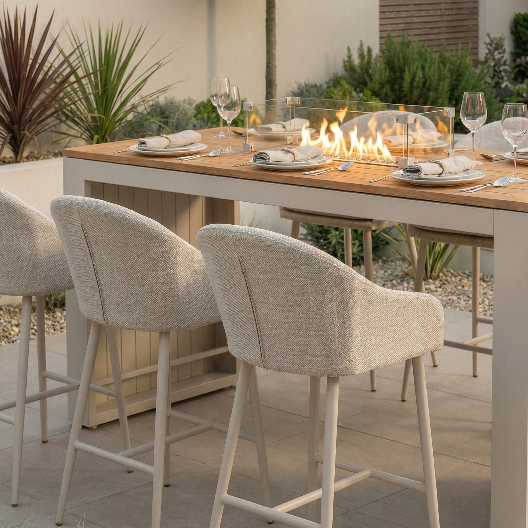 The Luna 6 Seat Outdoor Fabric Teak Firepit Bar Set in Fawn features a built-in firepit, all-weather materials for durability, and includes six chairs—perfect for stylish outdoor dining.